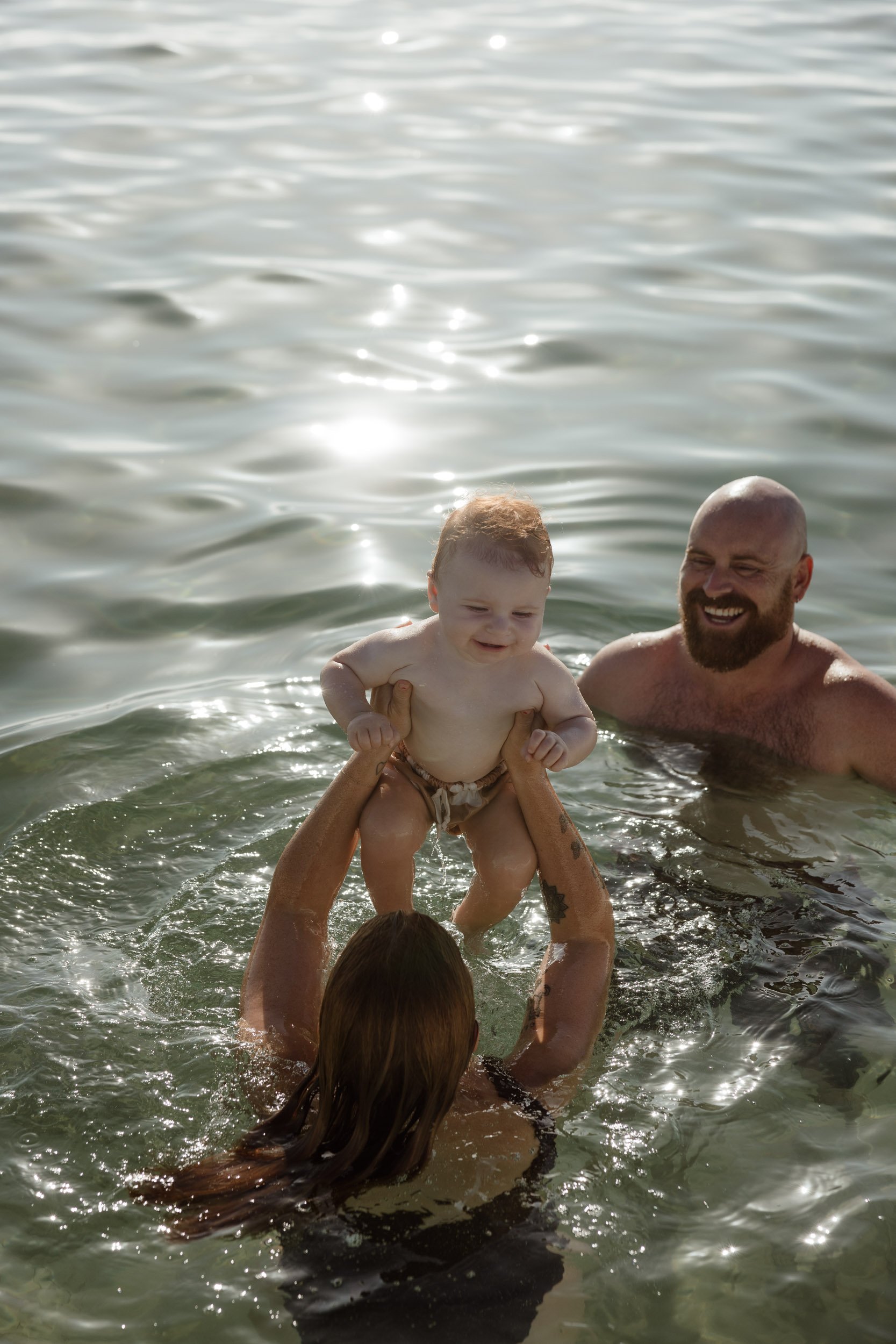 Young family enjoying summer at Newcastle Ocean Baths captured by Newcastle family photographer