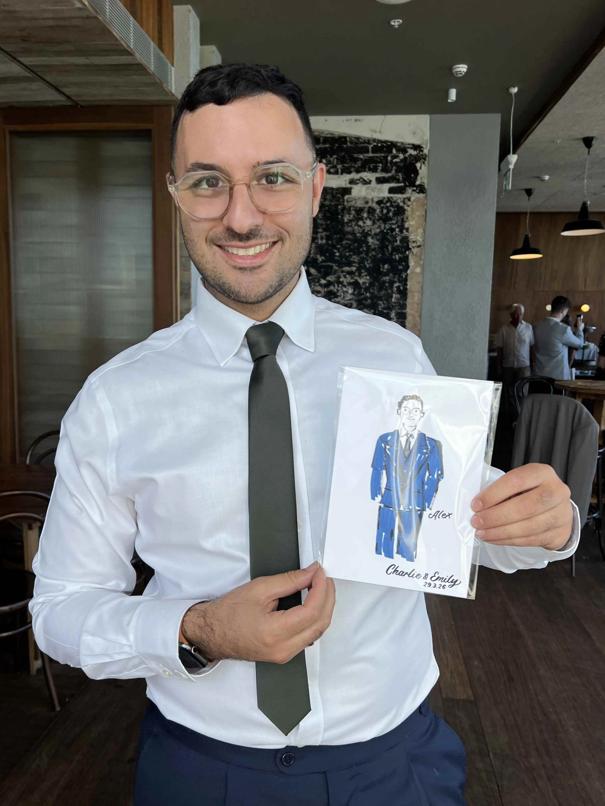 Wedding DJ smiling while holding their custom live illustration at a Sydney wedding