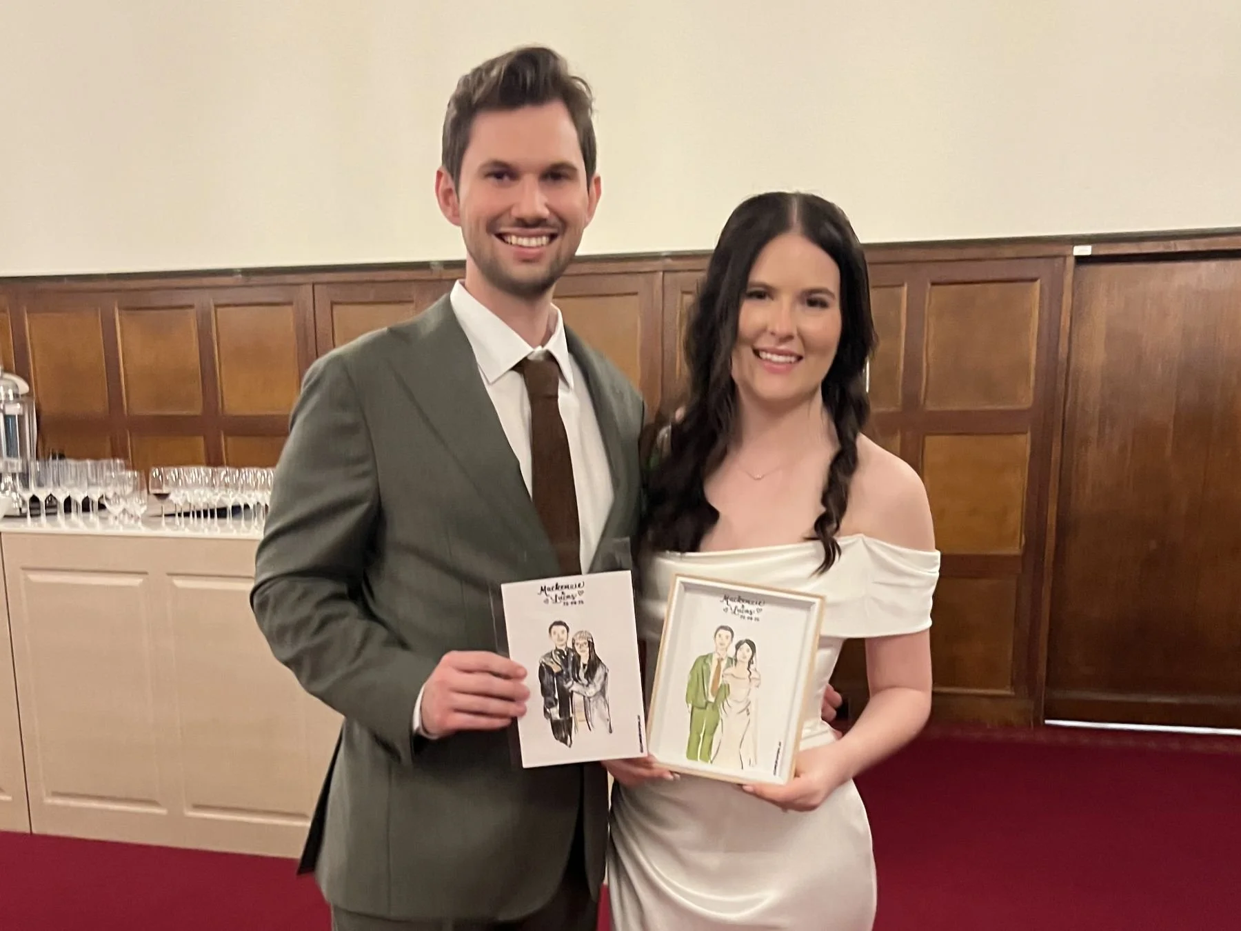 Wedding couple holding a live illustration of themselves