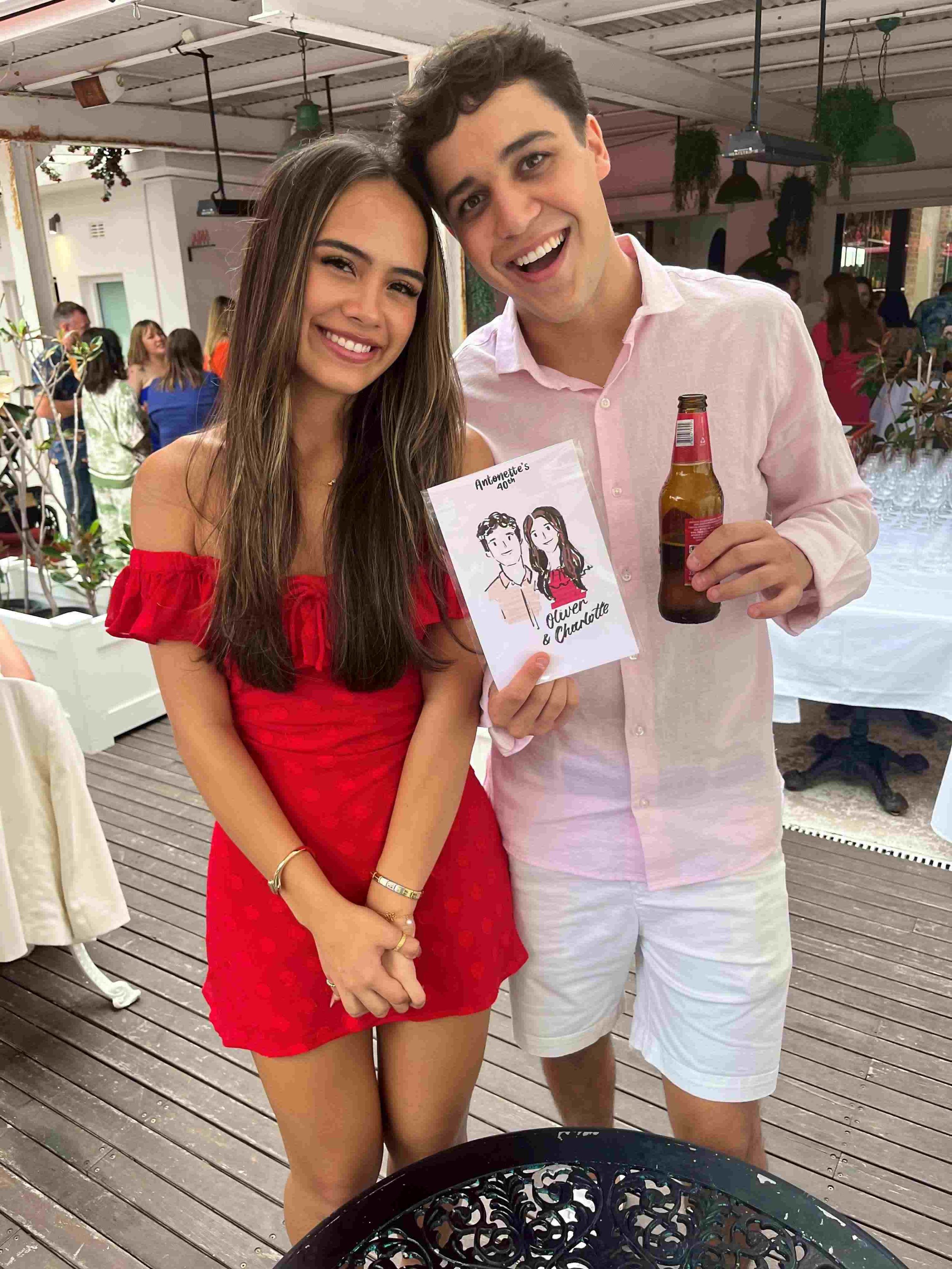 Couple smiling and holding their custom live illustration at a birthday party in Sydney