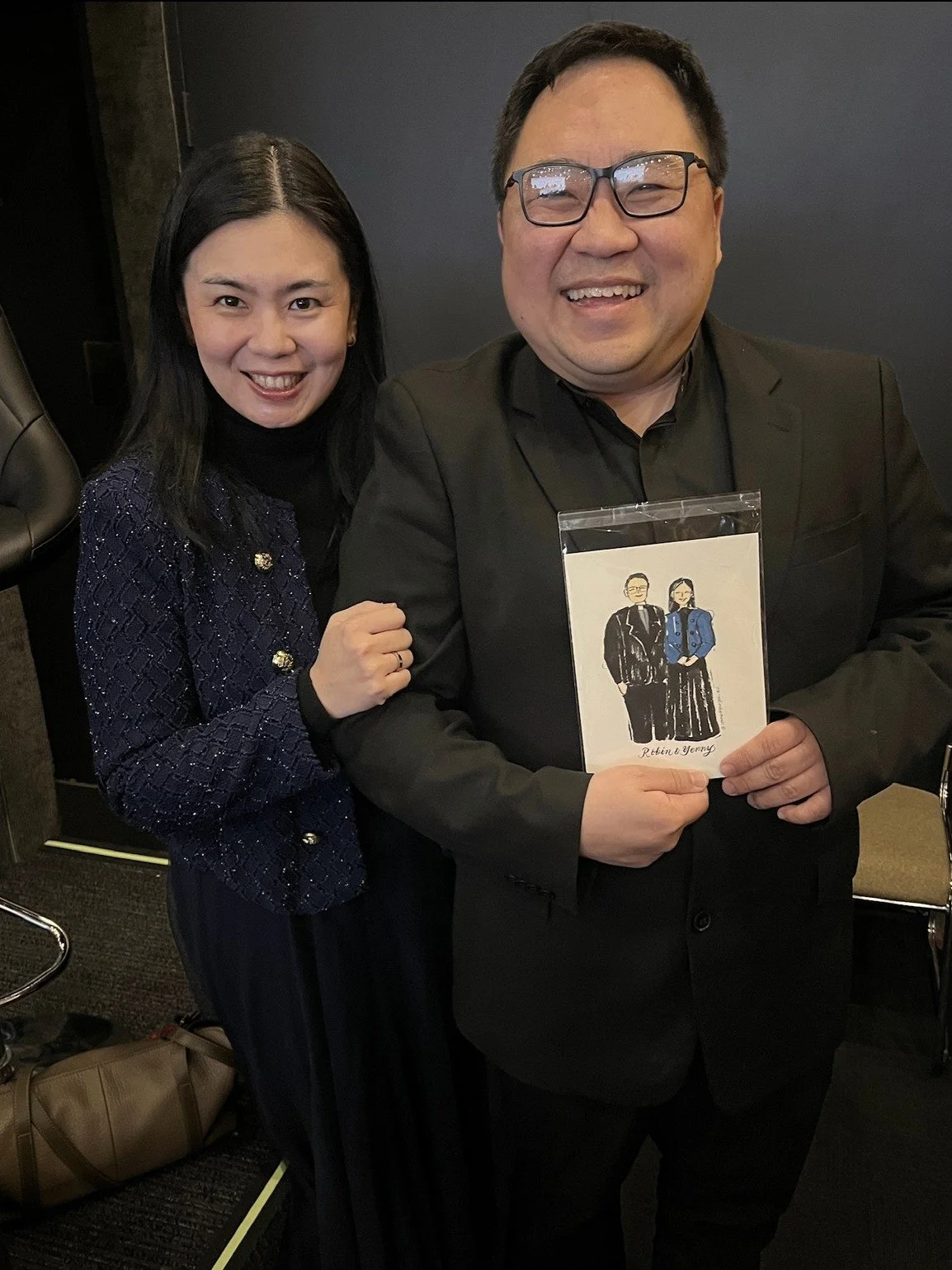 Wedding celebrant smiling while holding their custom live illustration at a Sydney wedding