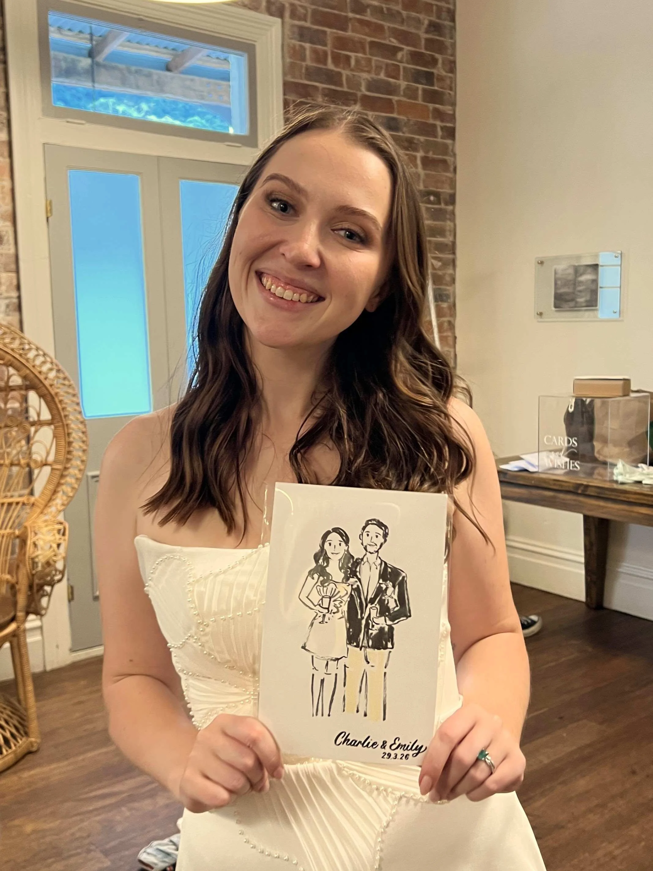 Bride in her wedding dress smiling while holding her custom live illustration at their Sydney wedding