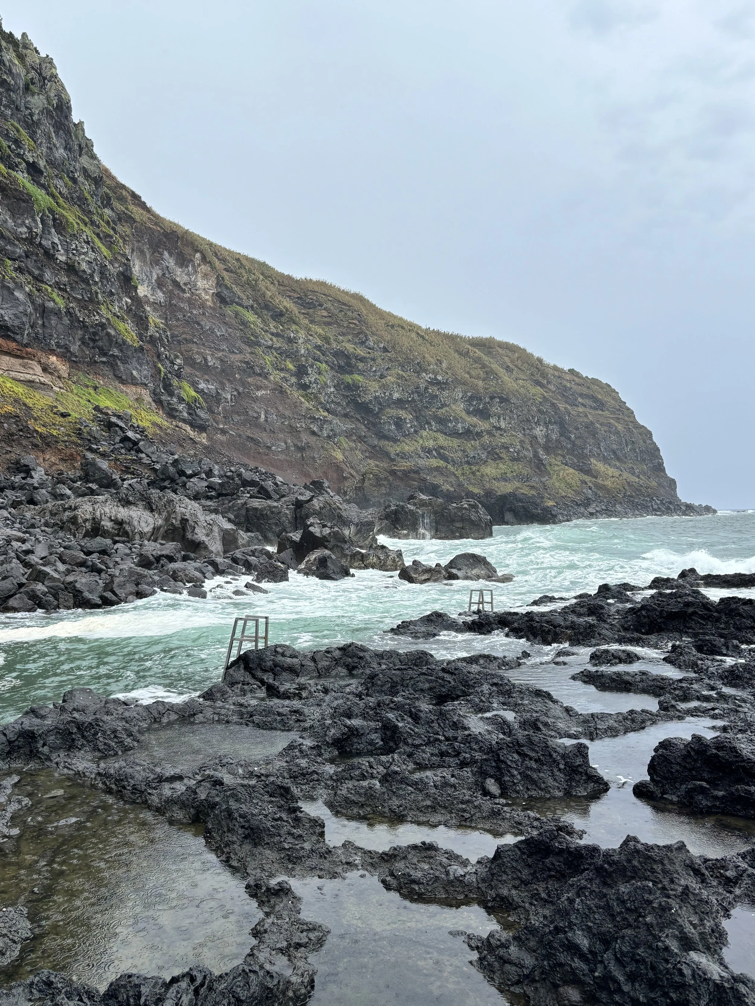 Natural thermal pool at Ponta da Ferraria, São Miguel — warm volcanic water meets the Atlantic in this Azores must-see.