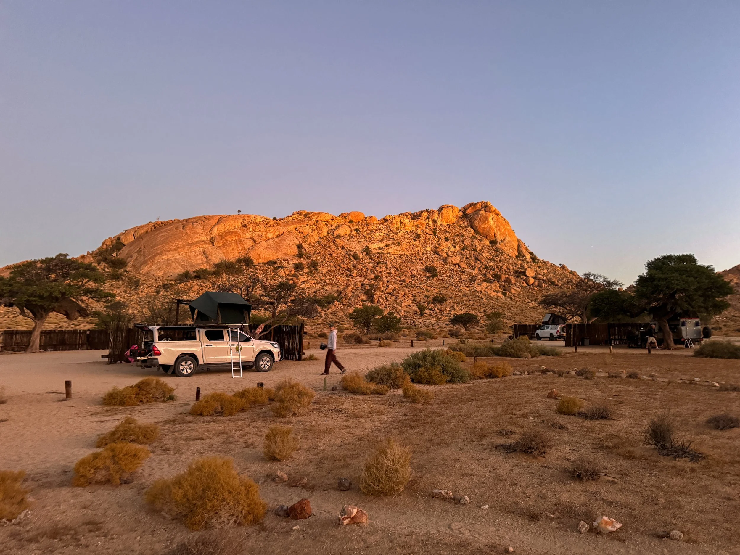 Camping with 4x4 with rooftop tent in the small desert town of Aus, Namibia surrounded by open landscapes and mountains