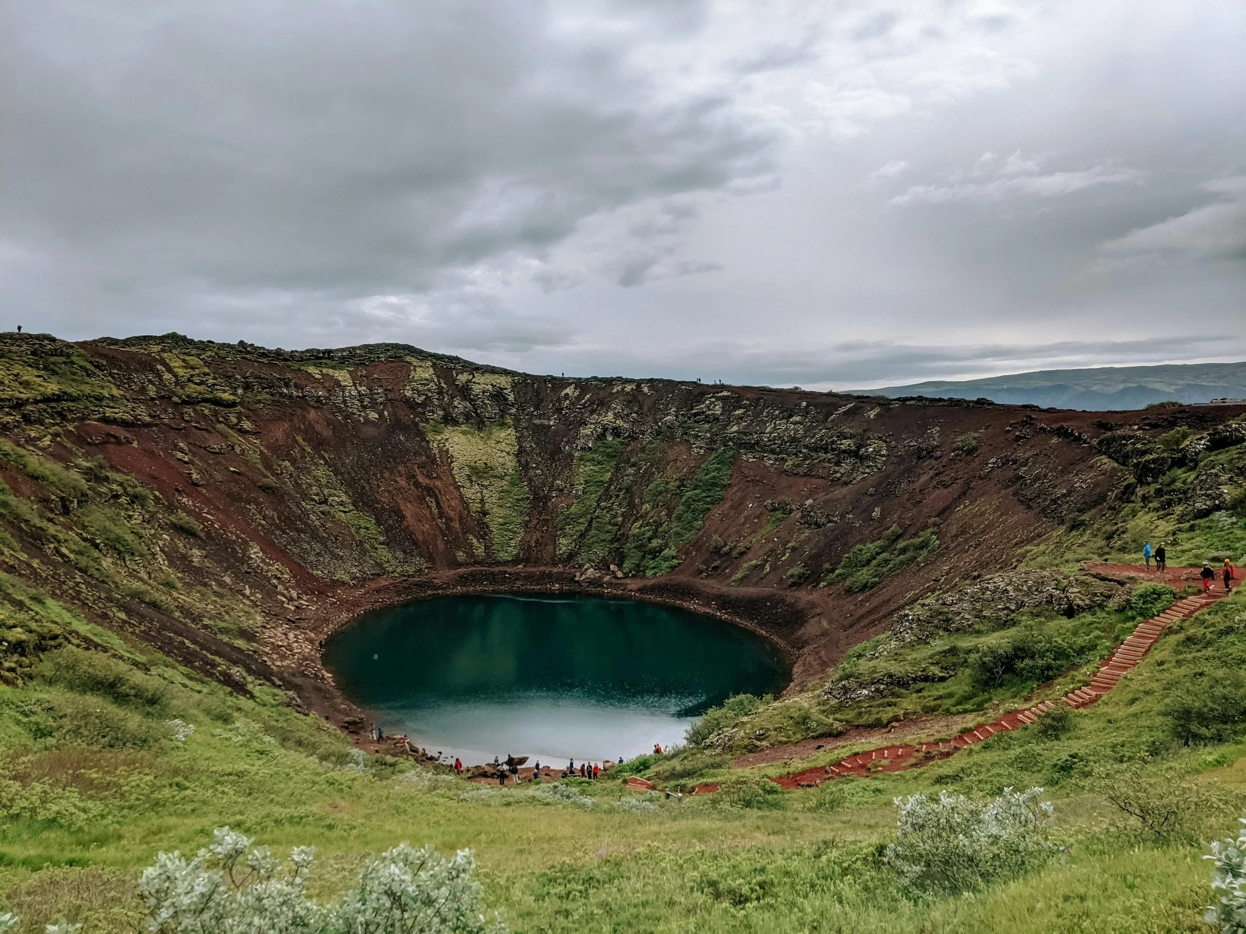 Kerið volcanic crater lake with vivid blue water — must-see stop on the perfect Iceland road trip.