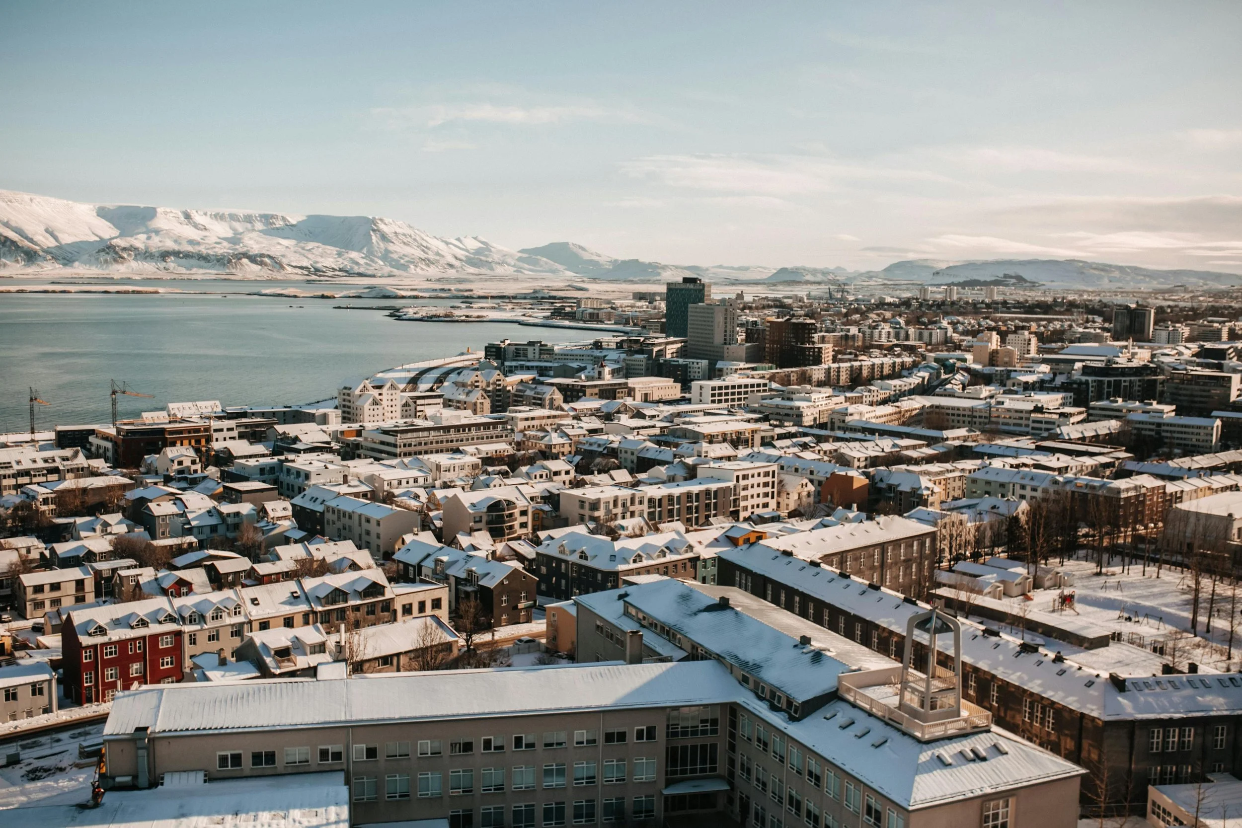 Sunset over Reykjavík’s colorful houses with Hallgrímskirkja church — urban stop in Iceland road trip itinerary.