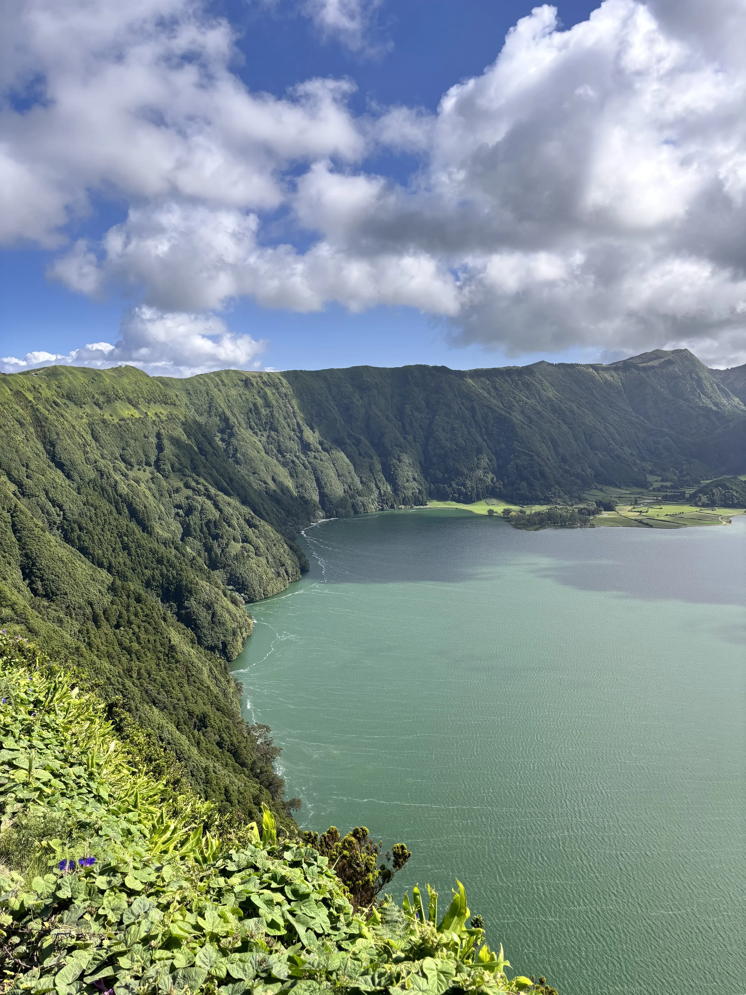 Sete Cidades crater lakes (blue and green) surrounded by forest hills — must-see places in São Miguel.