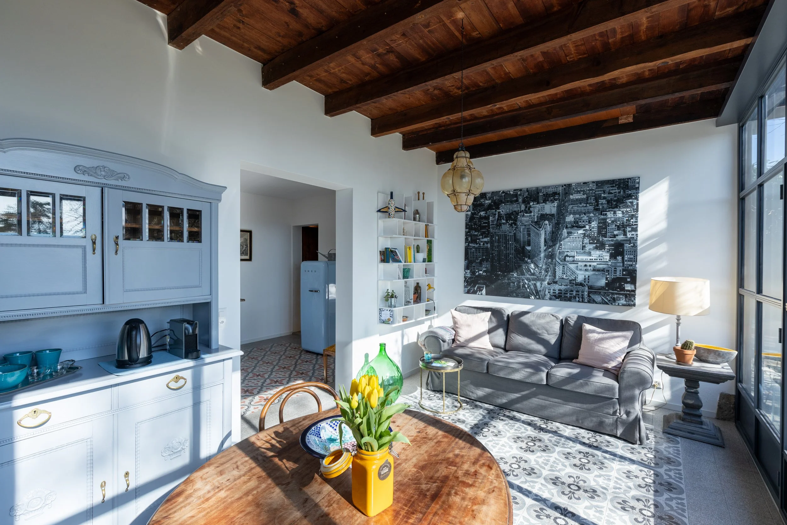 Bright, spacious living room with a comfortable sofa bed and dining area.
