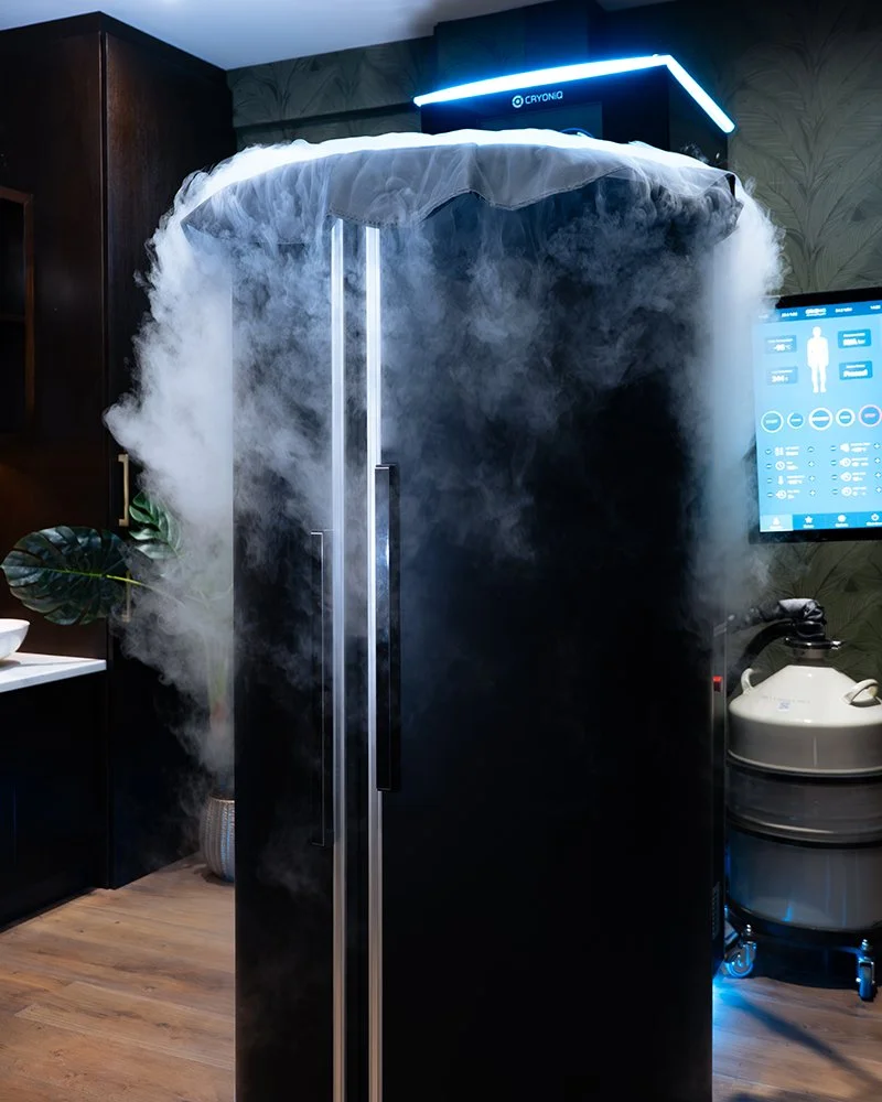 Cryotherapy chamber blowing cold vapor in a modern room.