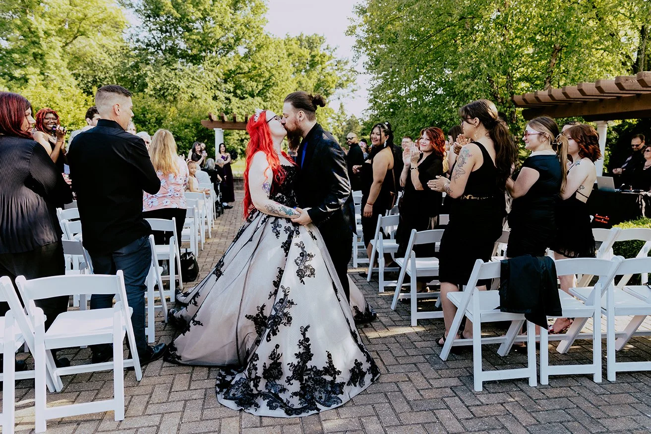 Couple kissing at the end of the aisle at Fern Hill Golf Club