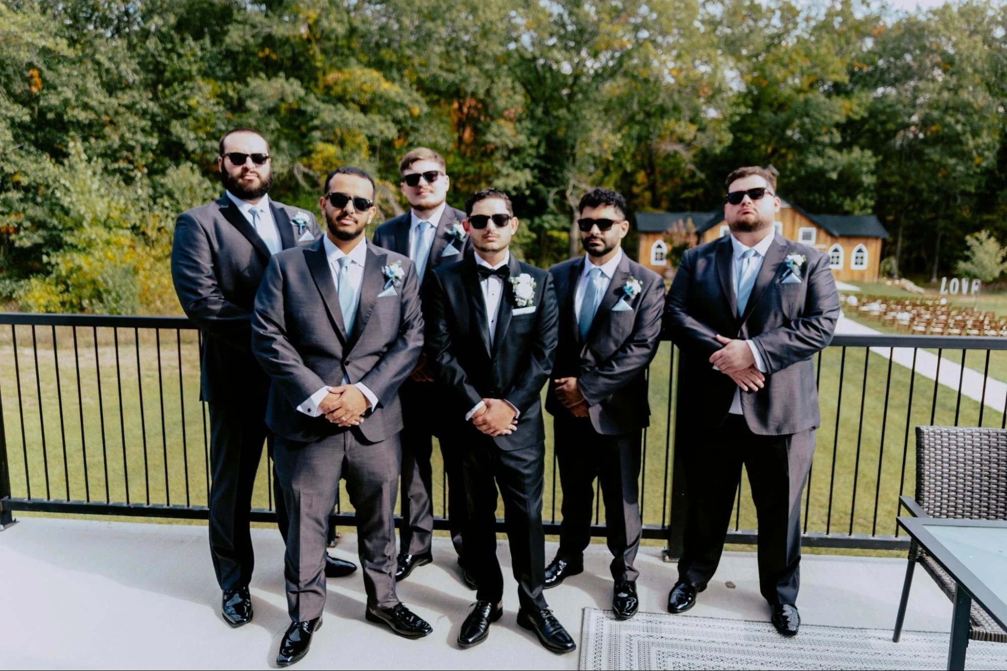 Detroit wedding photographer capturing the groom and his groomsmen posing together in stylish suits before the wedding ceremony.