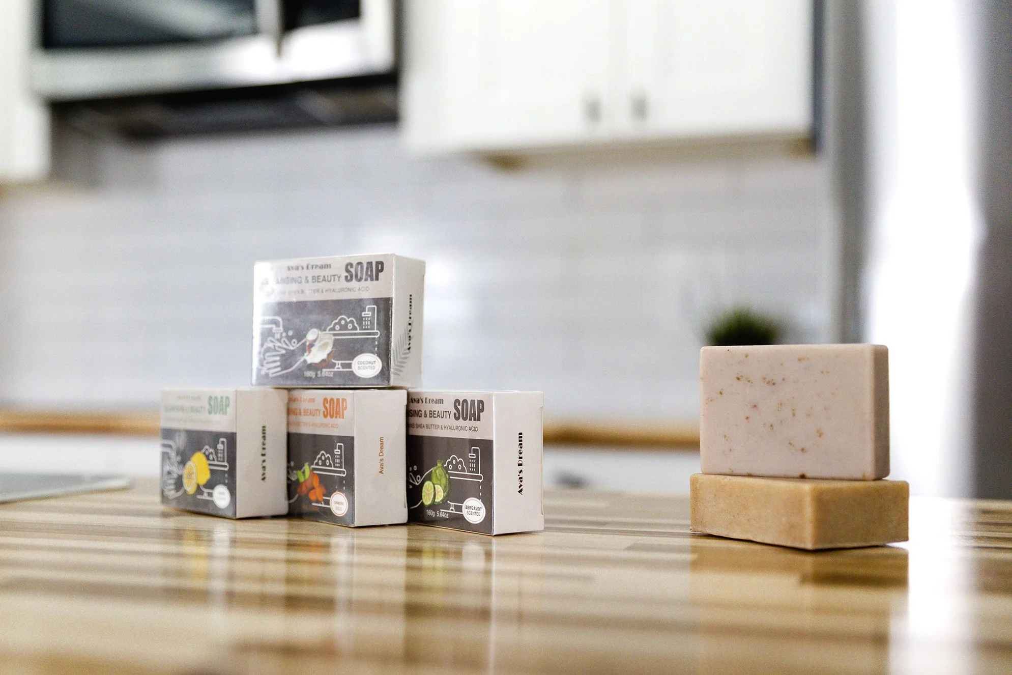 Ava's Dream Cleansing and Beauty soaps stacked on top of eachother. Four boxes of them on the left in the package and two bars of soap outside the package on the right of the image.