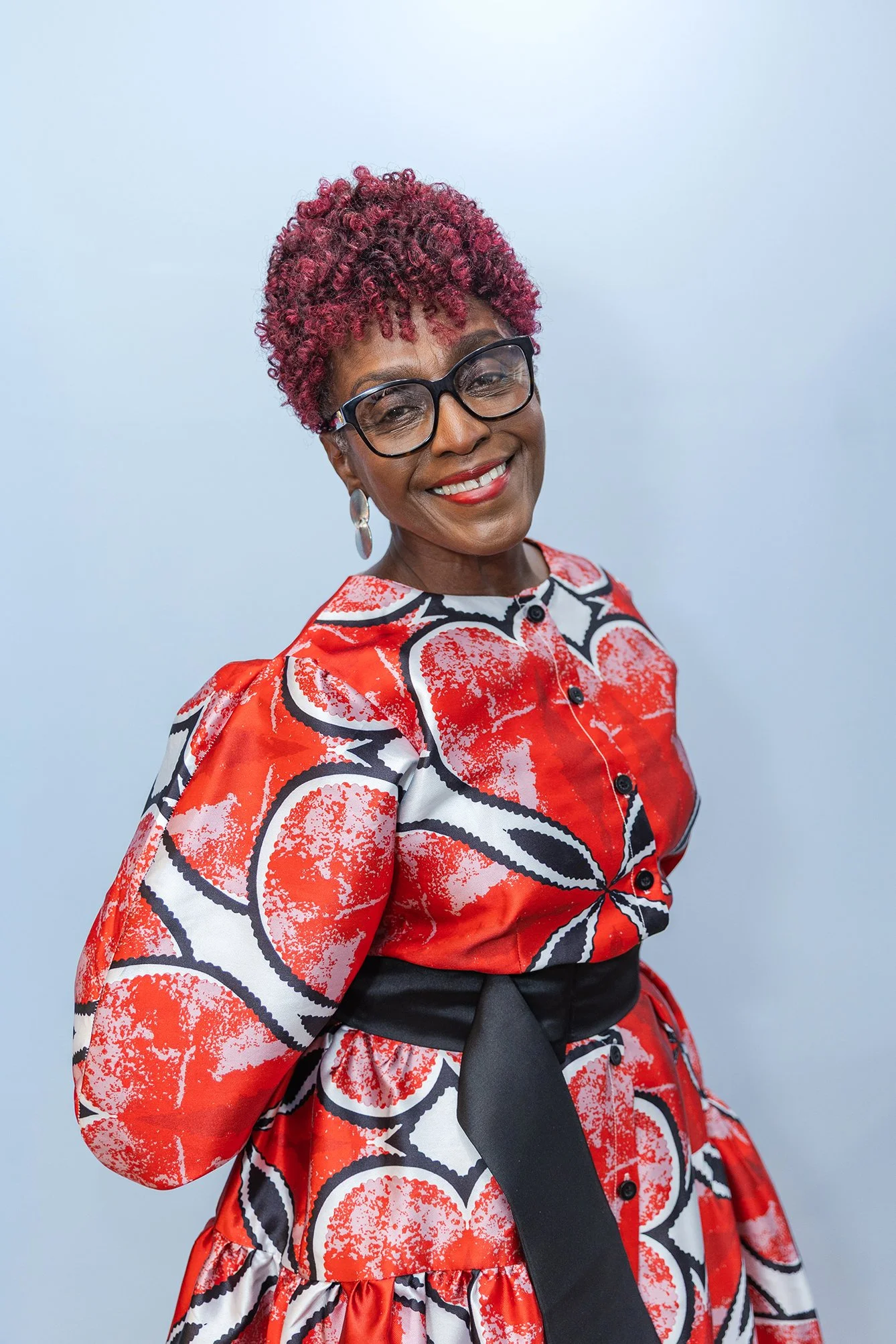 Detroit Entrepreneur Ava Jackson in a red dress smiling at the camera.
