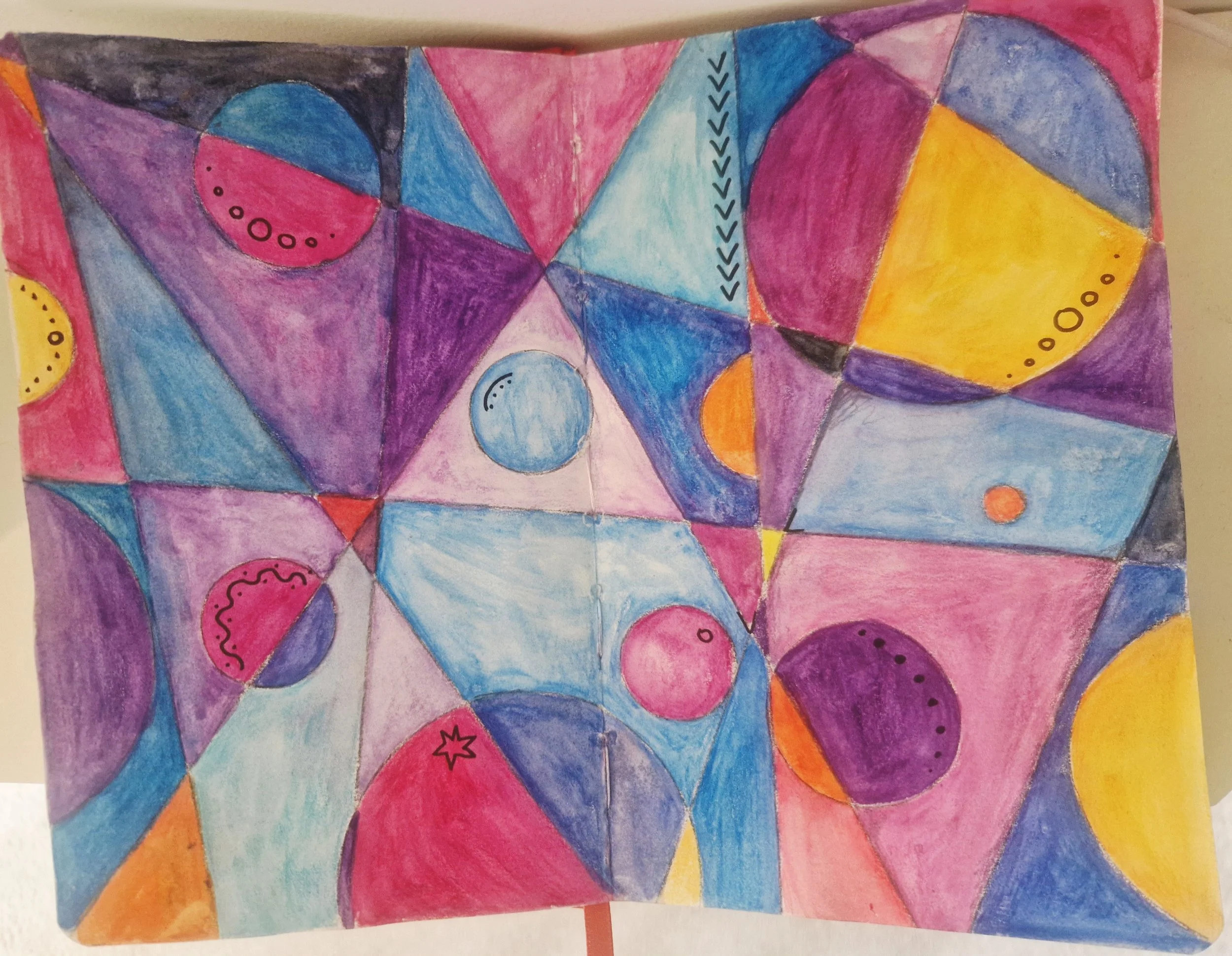 A sketchbook page with overlapping circles and lines in watercolour