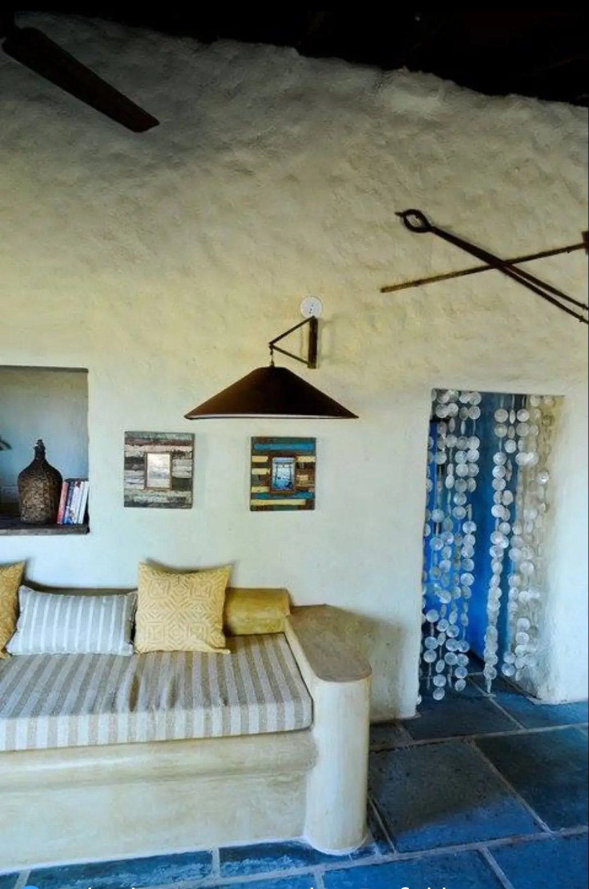 The only remnants of the pizza house are kept above the internal doorway. The sofas are in brick, moulded cement and yellow oxide IPS with mattresses and cushions added. The strung mother-of-pearl shells I found in a ditch and hung in the doorway. Th