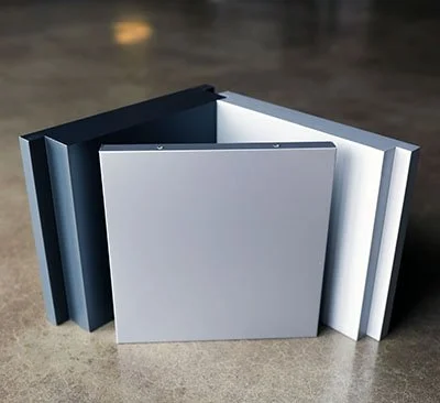 A collection of glazed-in panel 2mm and 3mm plate systems arranged in a semi-circle on a concrete surface.