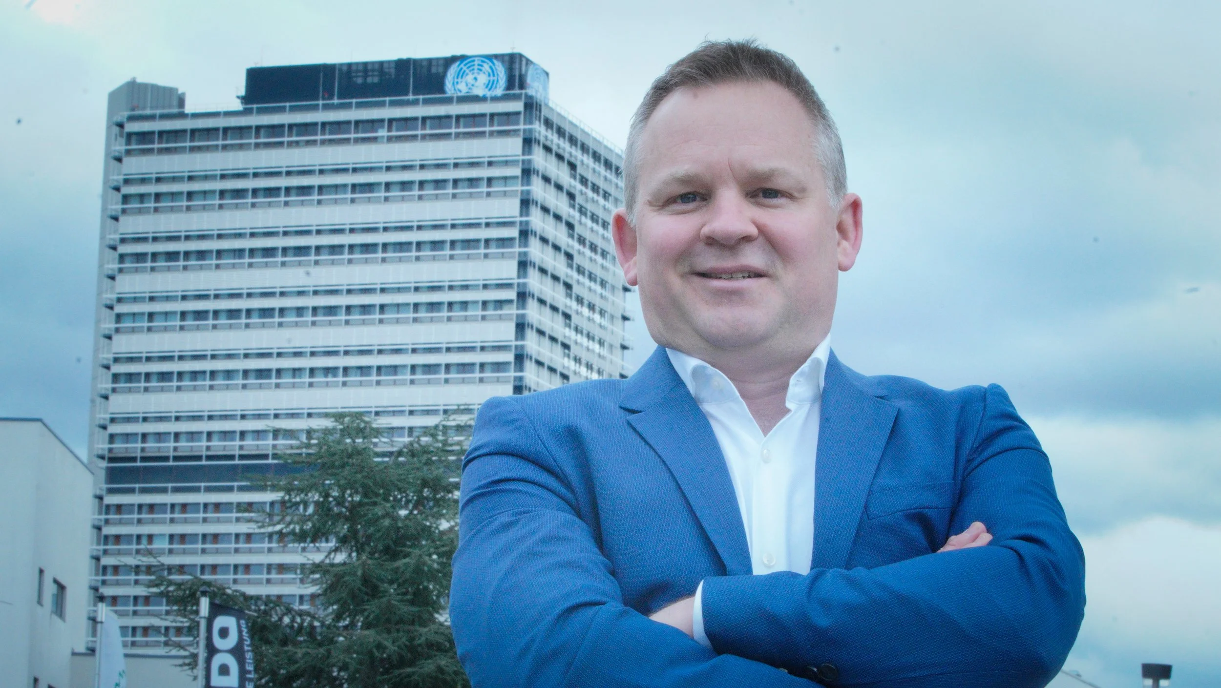 Executive Speechwriter and AI For Leadership Communications Trainer Brent Kerrigan in front of the UN buildings in Bonn, Germany