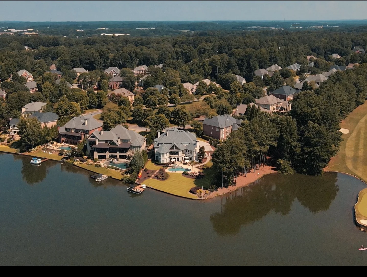 Cinematic aerial still from a lakefront property video tour
