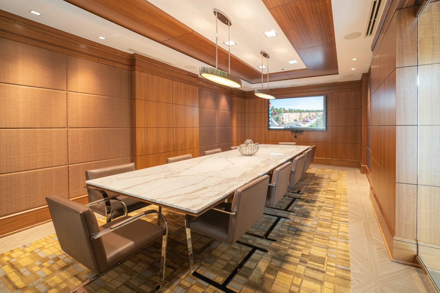 Wood-paneled commercial conference room with long meeting table