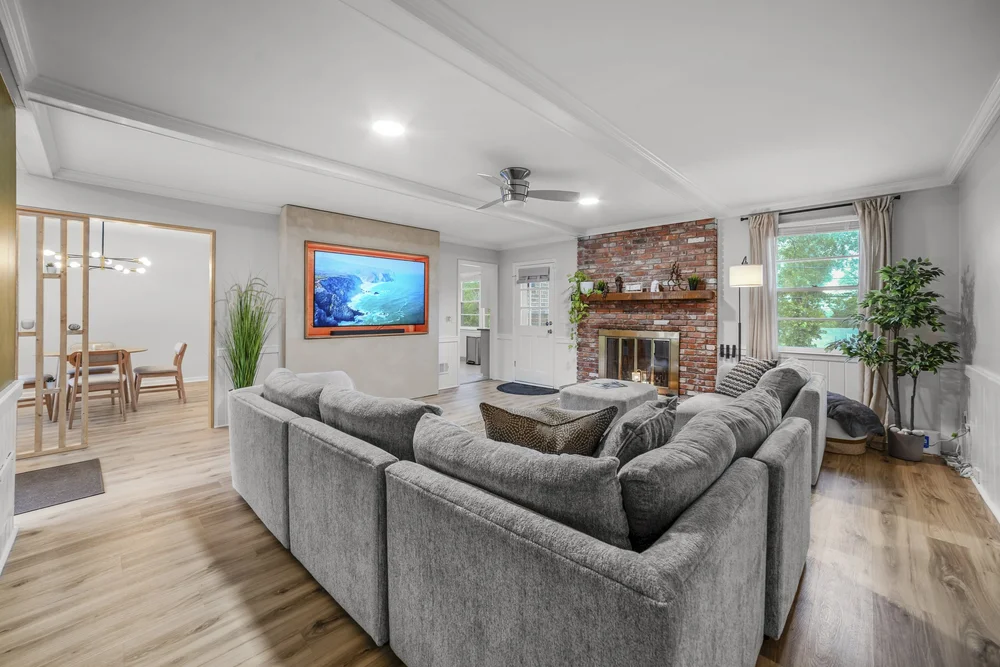 Residential living room with fireplace and open dining area