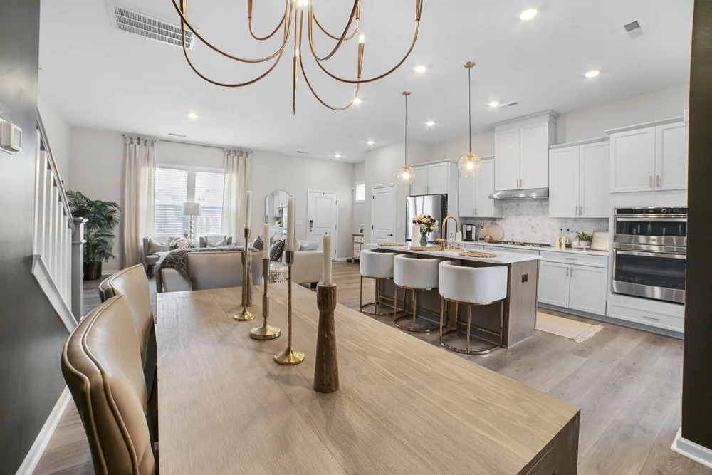 Modern residential kitchen with island seating and chandelier
