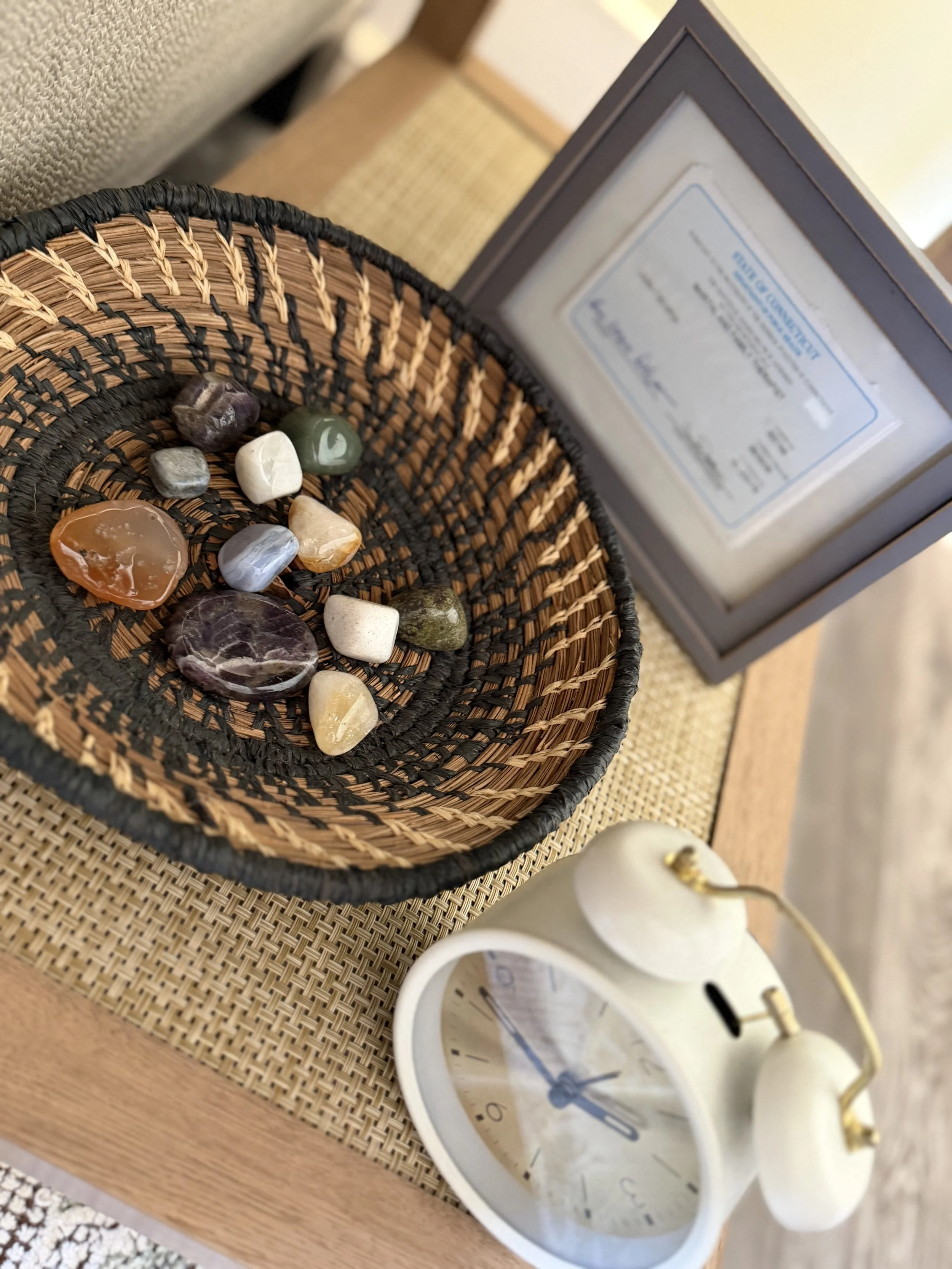 Healing crystals by Connecticut therapist license in therapy office.
