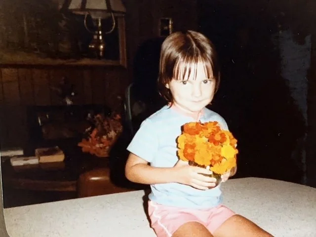 Natasha in Ethel's kitchen with fresh-picked marigolds from Ethel's garden