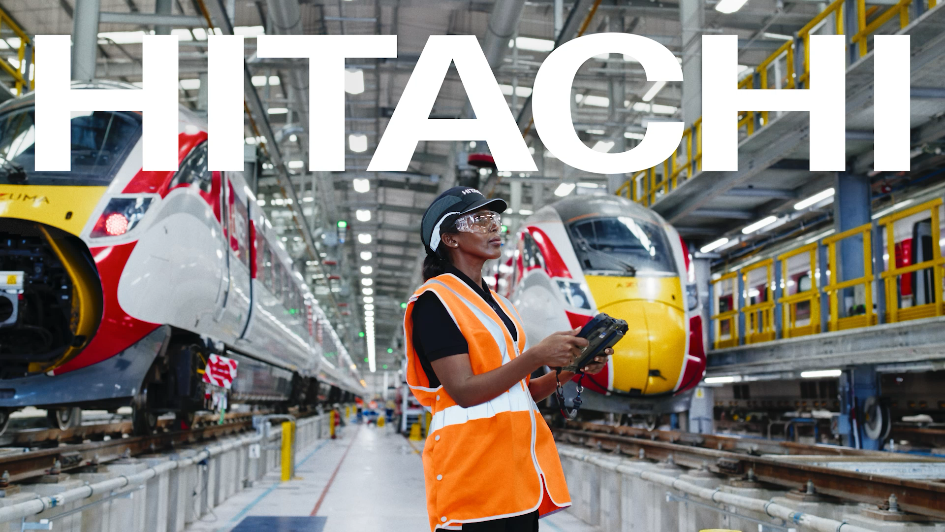 A woman inspecting trains, photographed for Hitachi's 'Inspire the next' campaign