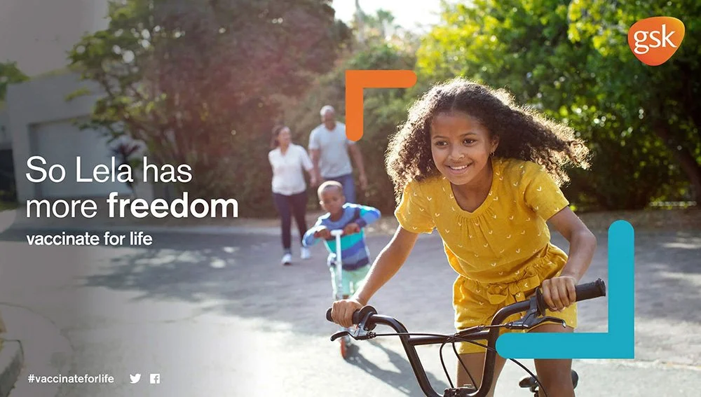 An image of a happy girl riding a bike in an advert for GSK