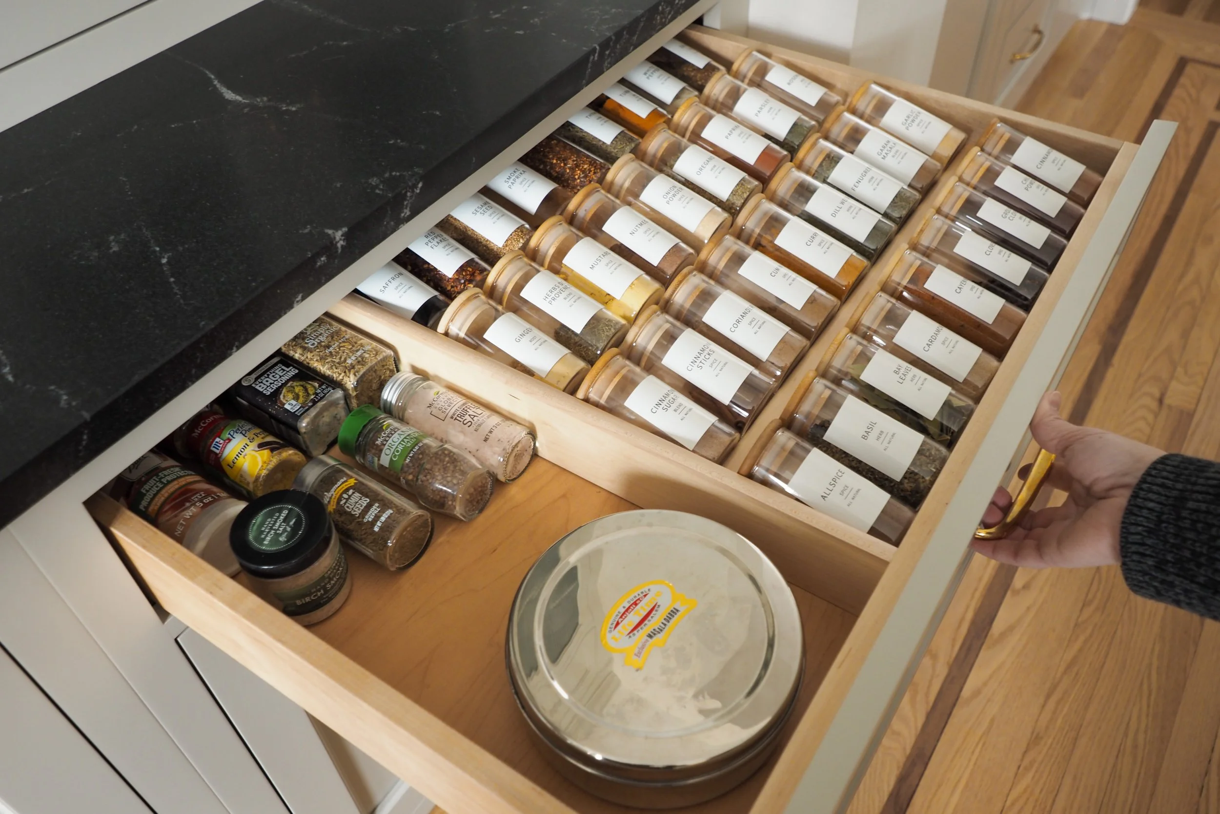 Custom spice drawer organization with tiered insert and labeled jars — Studied Milieux kitchen renovation, Haddonfield NJ