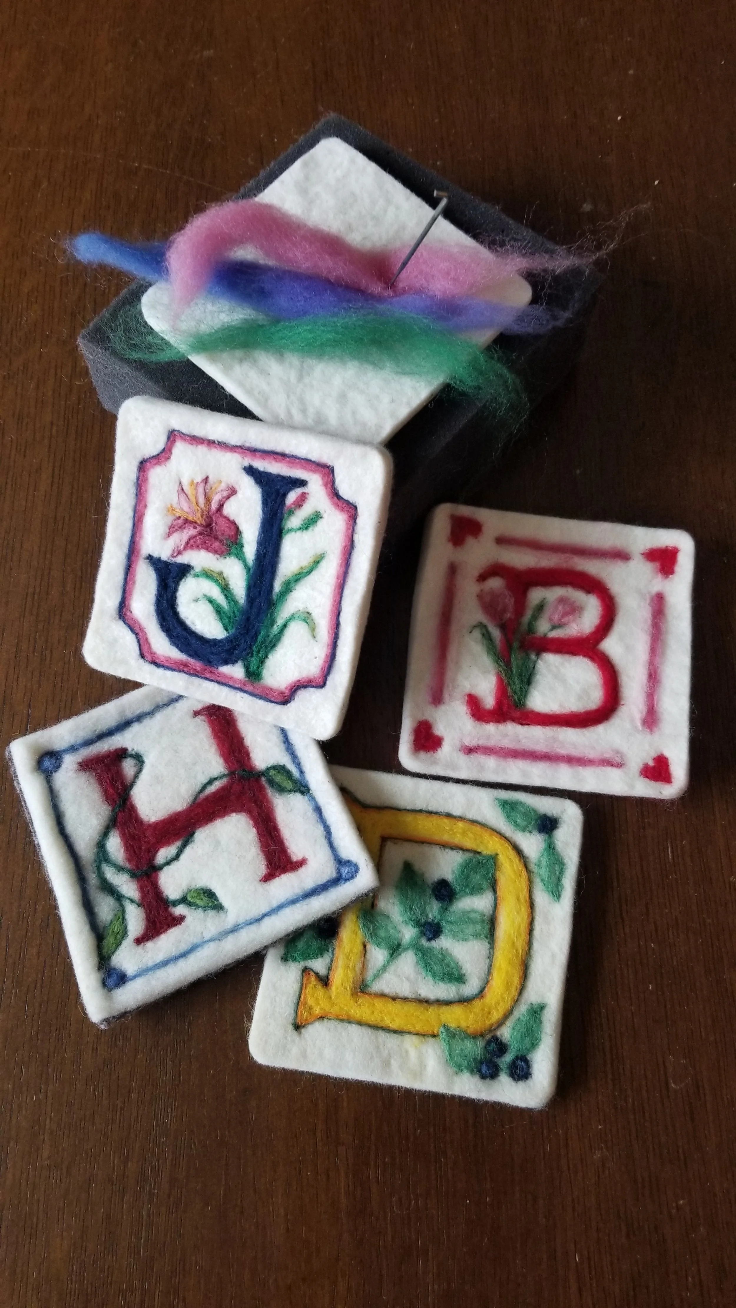 Illuminated letter coasters with roving, pad and needle.jpg