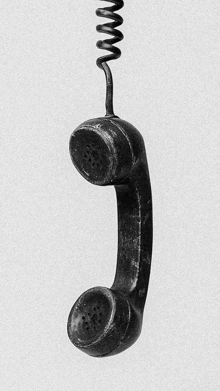 abstract image of a hanging phone on grey background