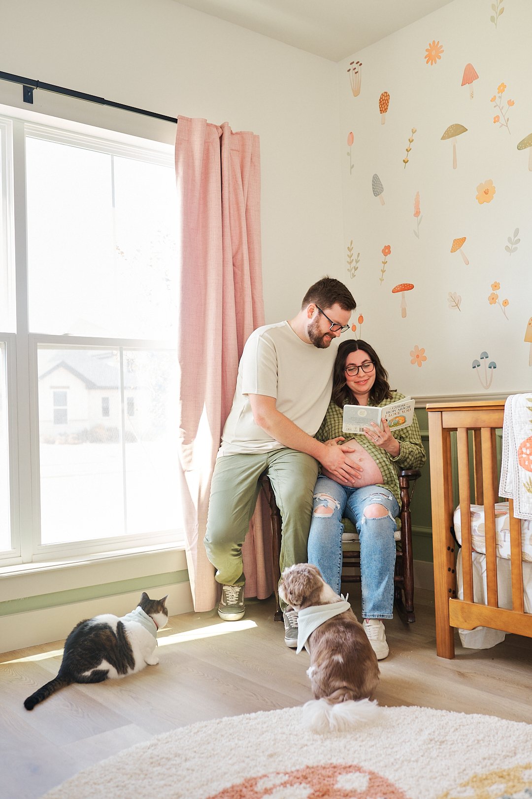 Couple Maternity portrait in nursery with their pets.jpg