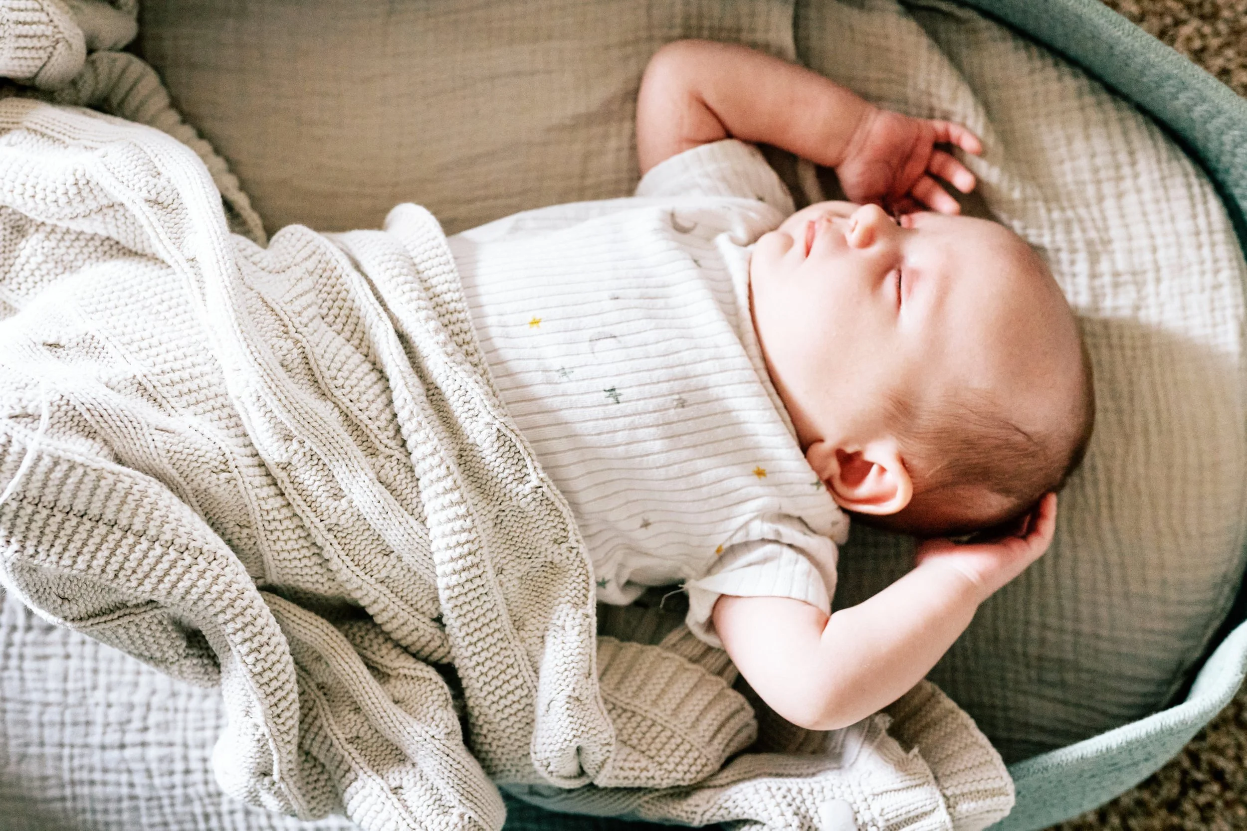 newborn baby sleeping in basket.jpg