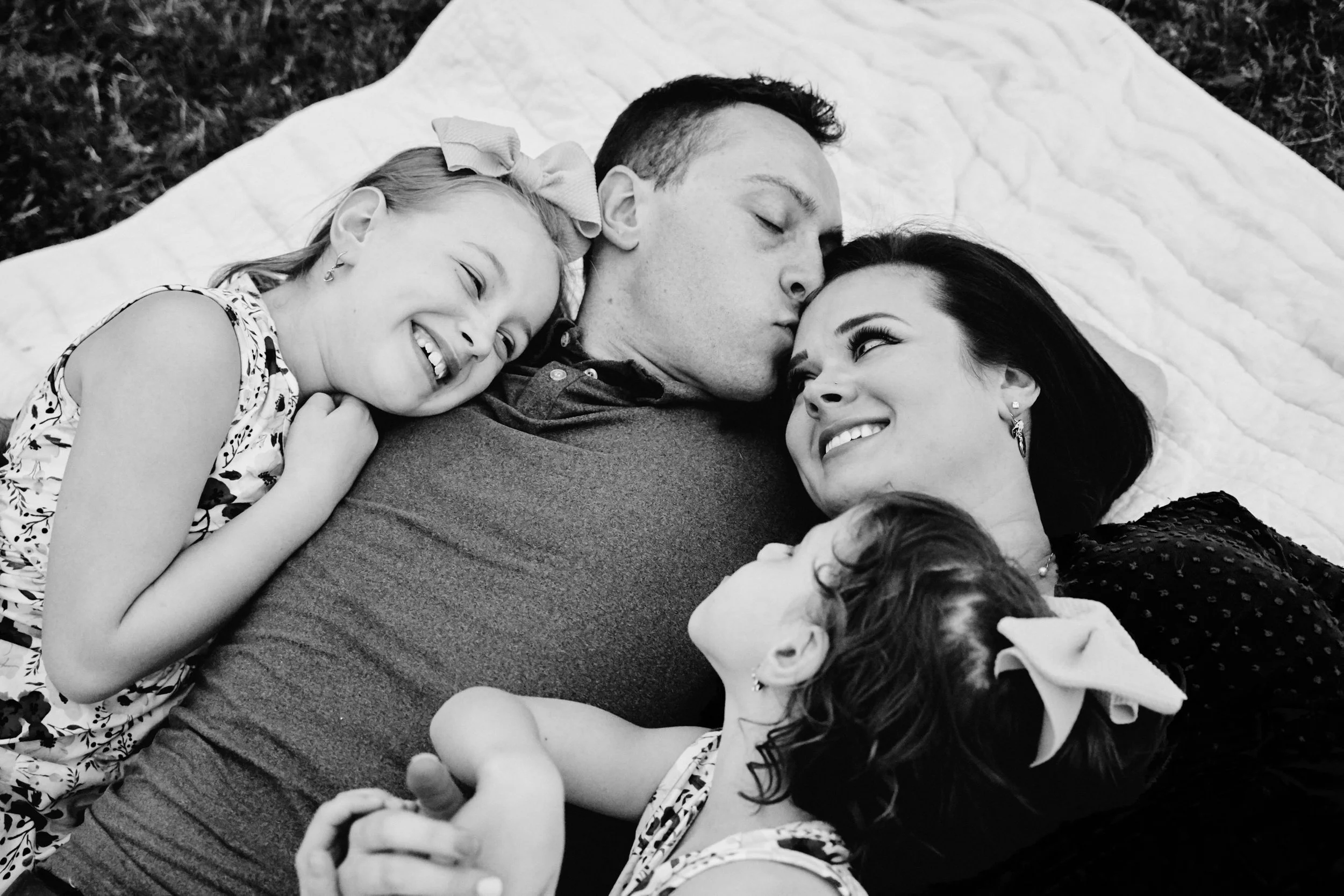 Black and White Family of 4 laying down.jpg
