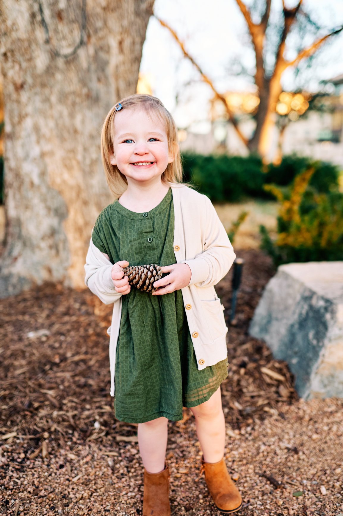 Toddler Outdoor portrait holding pinecone.jpg