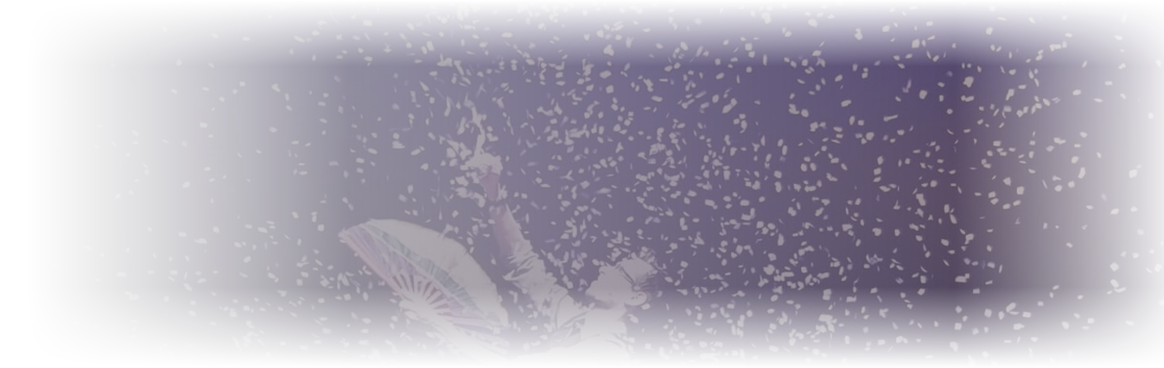 A performer with umbrellas on stage, surrounded by floating paper or confetti, under dark lighting.