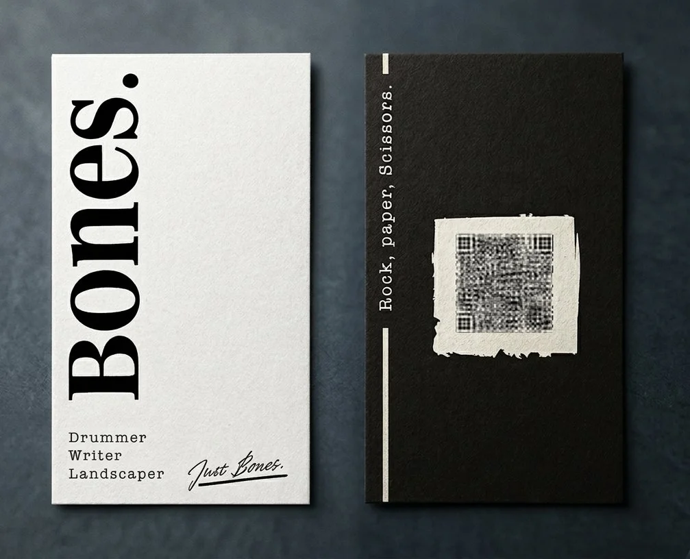 Two black and white business cards, one with the word "Books" in large bold letters, and the other with a QR code and text that reads "Rock, Paper, Scissors."