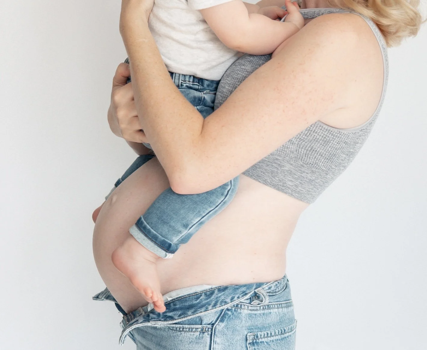 Maternity pregnant mum to be cuddling her toddler