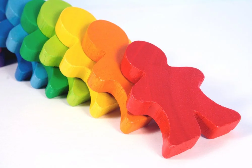 DEI colorful clay people falling over