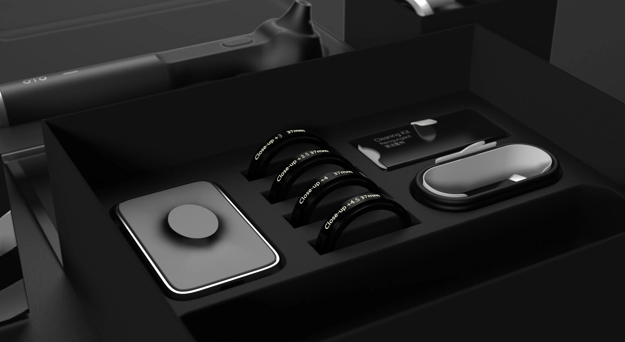 Close-up shot of Oto accessories including spare lenses and focus attachments arranged within the packaging insert.