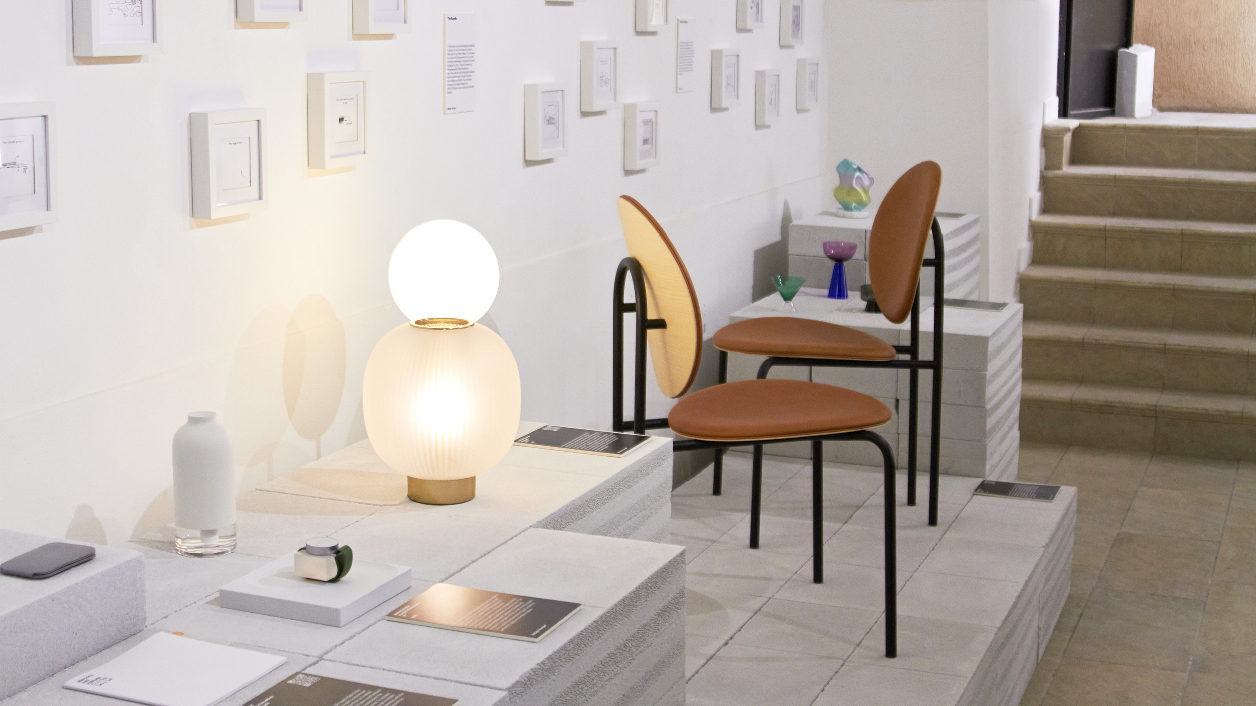 Close-up showing Tim Rundle’s lamps alongside his furniture designs, highlighting material and form.