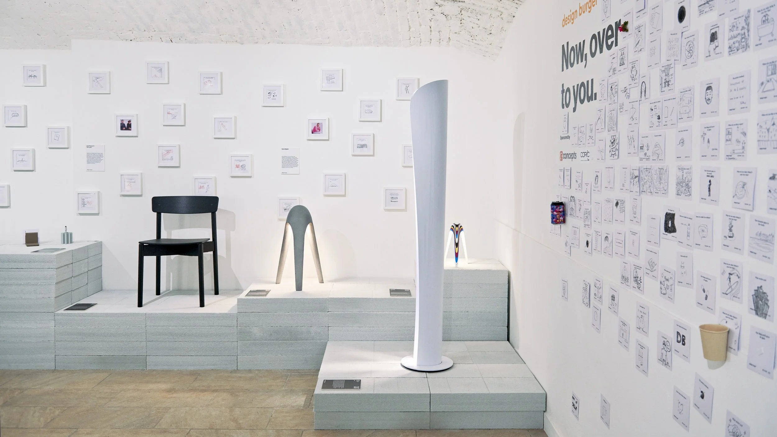 Exhibition corner featuring Artemide Cadmo floor lamp by Karim Rashid, his Cyborg lights, and a chair by Pearson Lloyd.