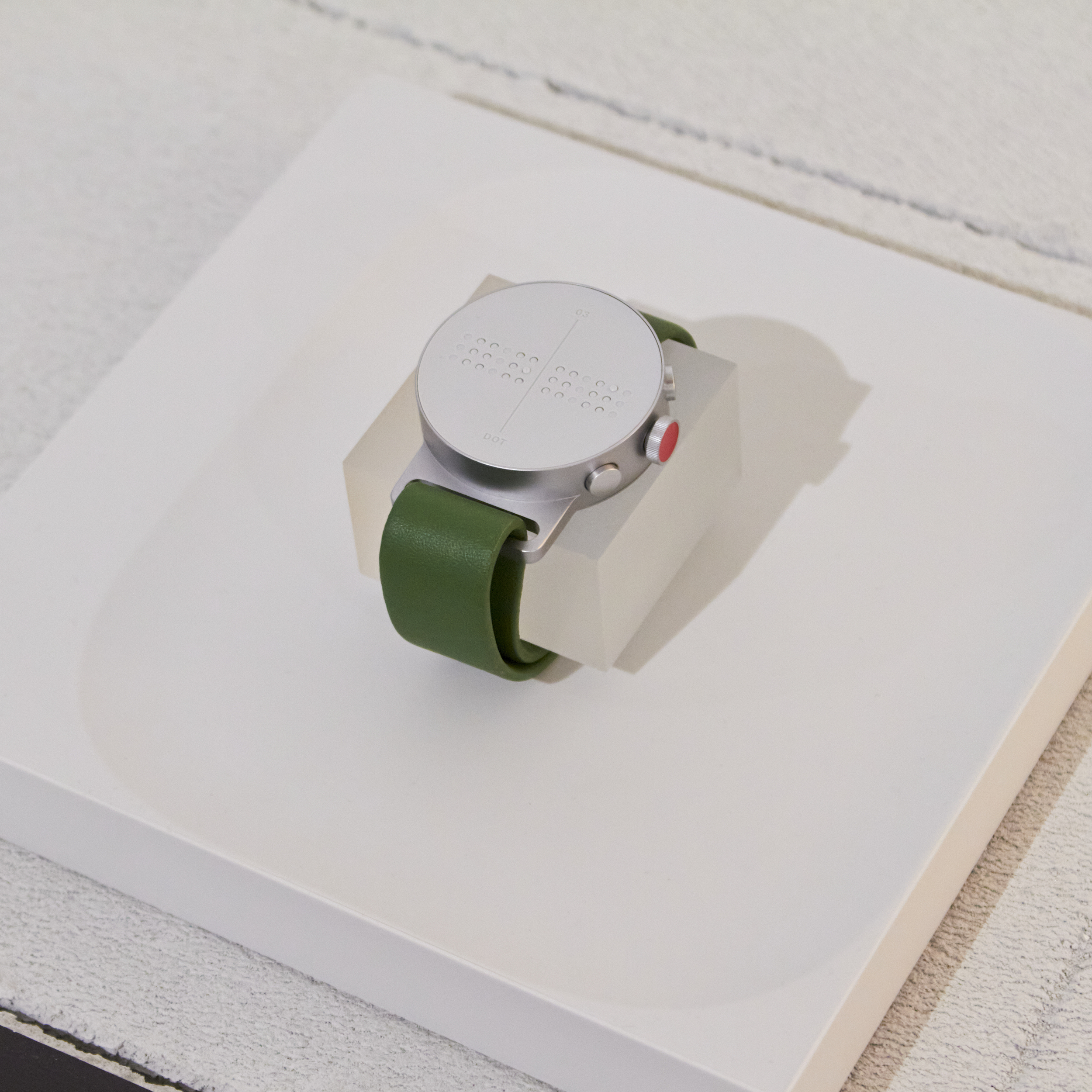 Close-up of Cloud & Co Braille watch by Yeongkyu Yoo displayed in the exhibition, highlighting accessible design features.