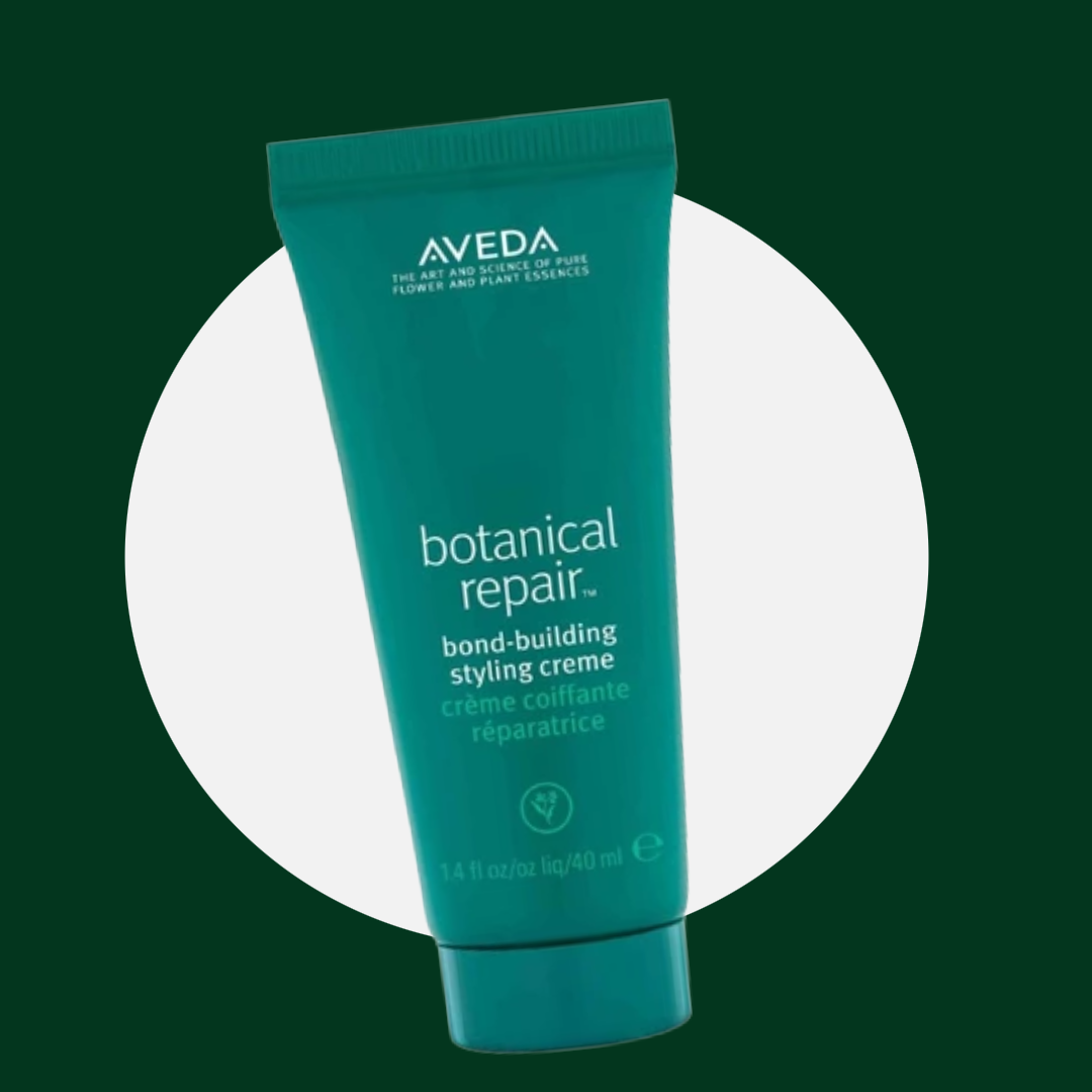 A teal tube of Aveda Botanical Repair bond-building styling crème with white and green text on the label.