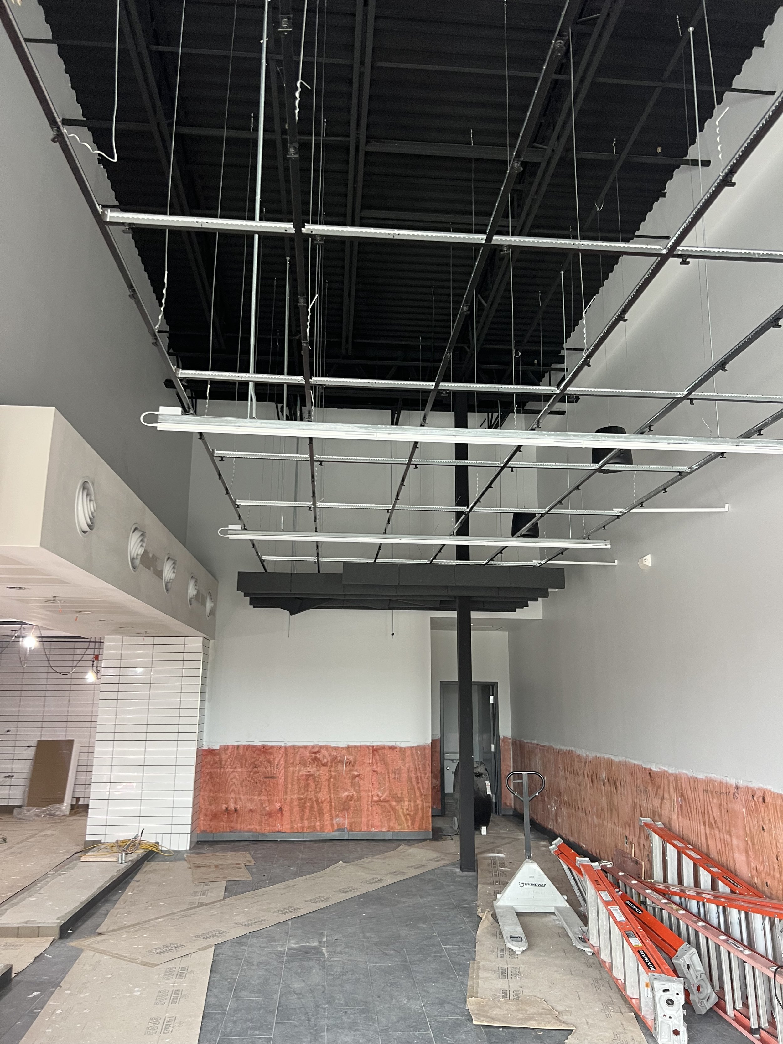 Commercial tenant improvement with open ceiling for electrical and lighting rough-in.