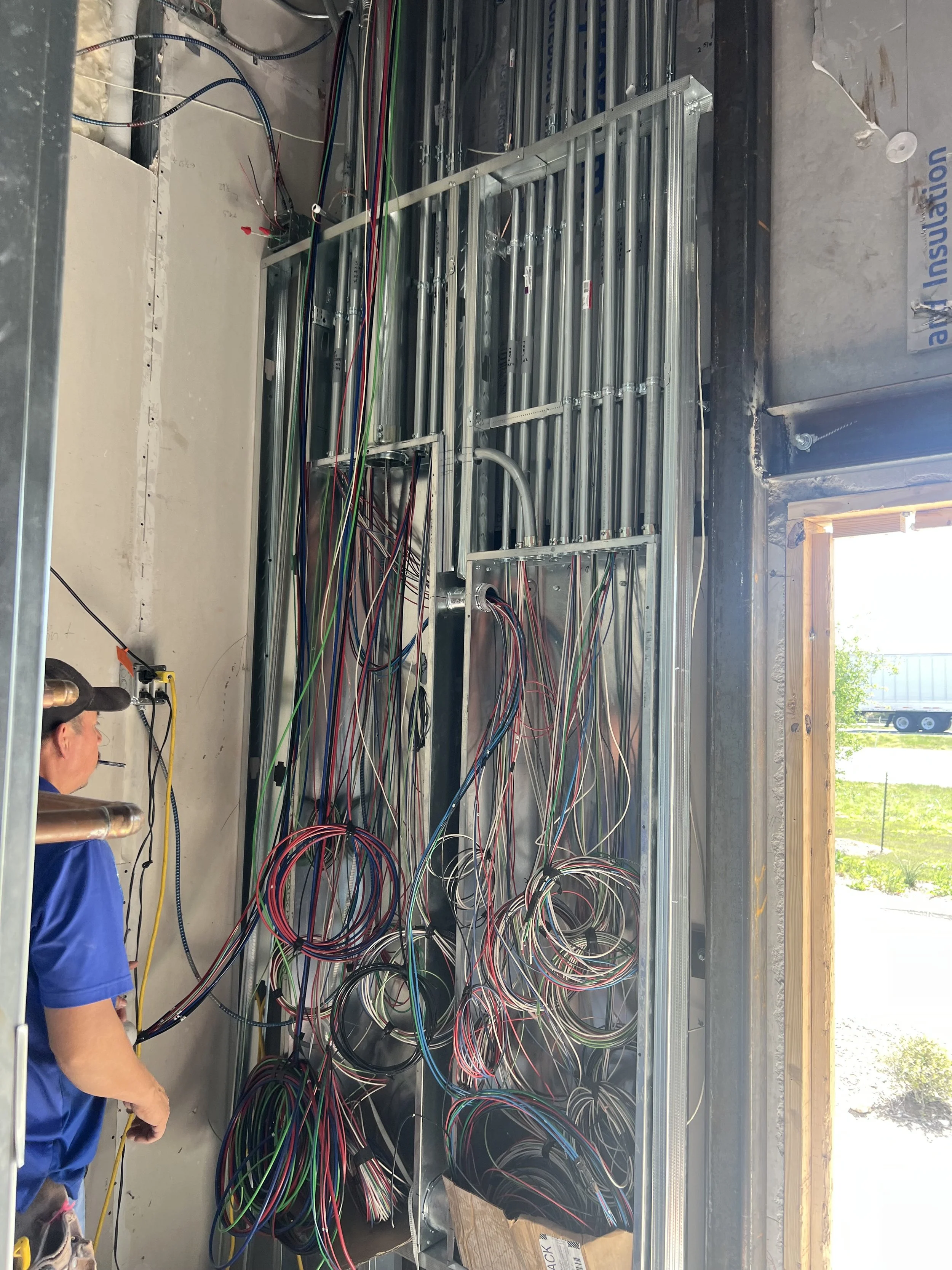 Licensed electrician inspecting wiring for code compliance in San Antonio commercial building