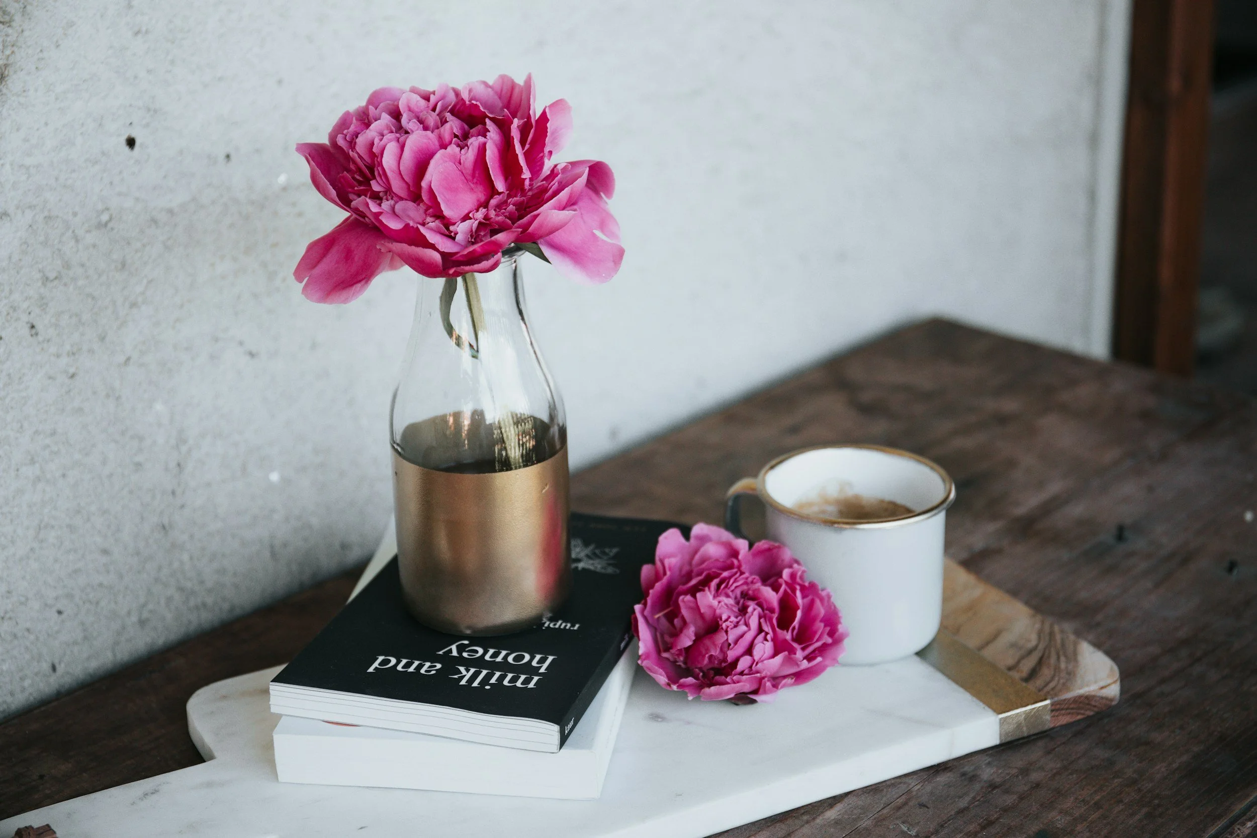 Pink flowers on books—boutique Orinda therapy practice offering East Bay therapy specializing in anxiety, depression, and trauma therapy.