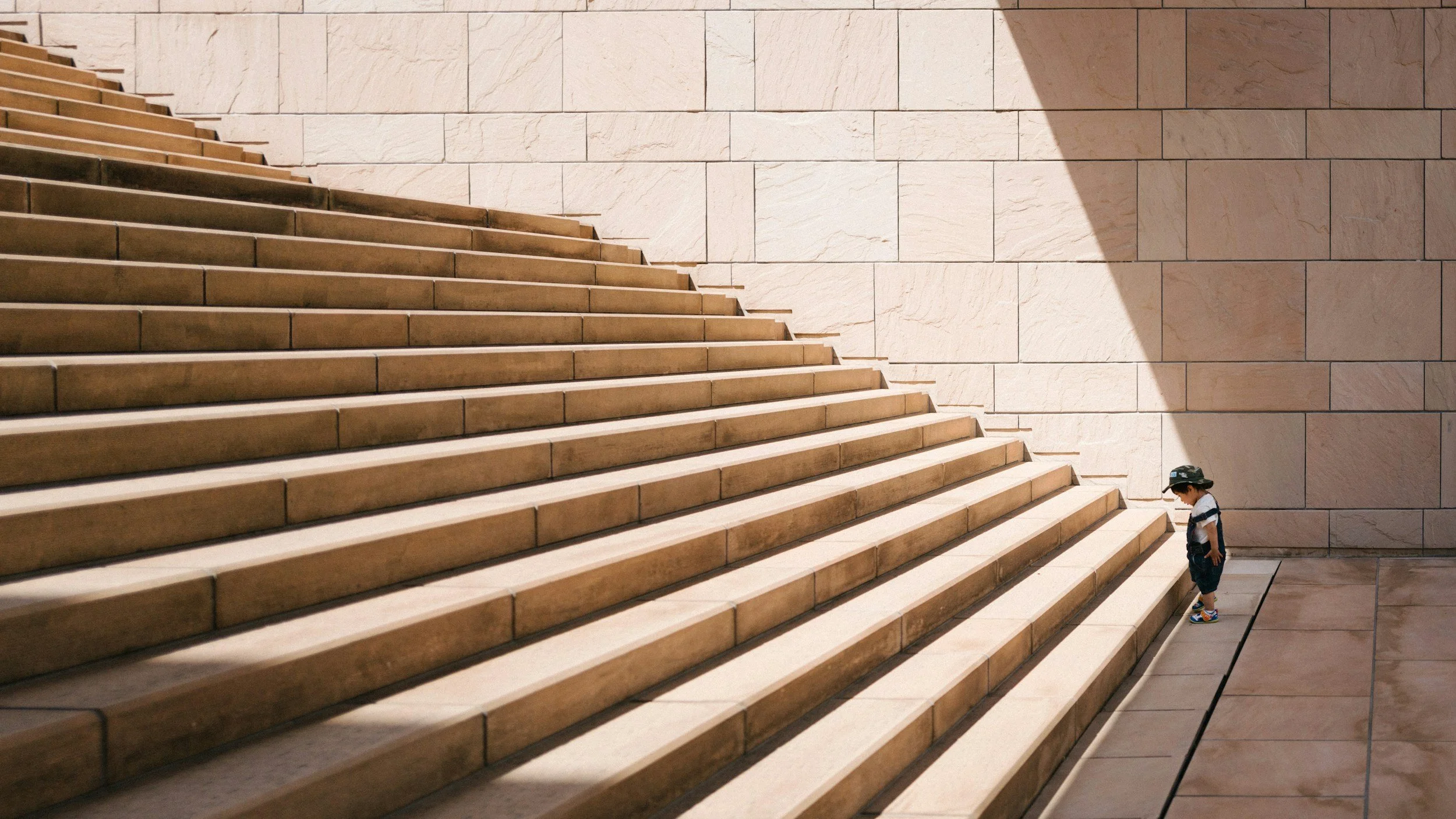 Boy at the bottom of a staircase, ready to take the first step toward healing and personal growth with Orinda therapy and Walnut Creek therapy.