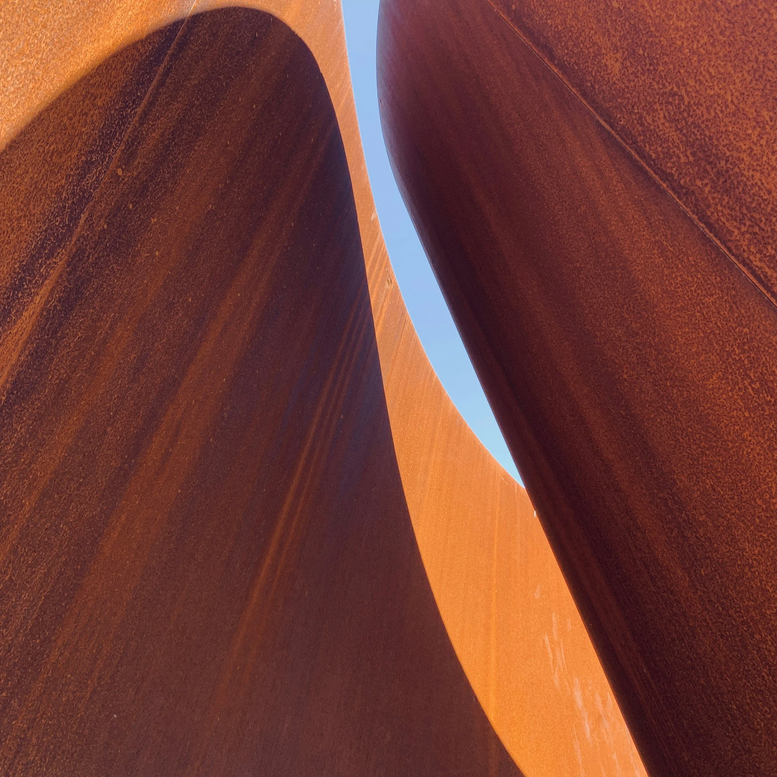 Abstract sandstone canyon walls with warm tones and sky above, representing calm, space, and natural balance.